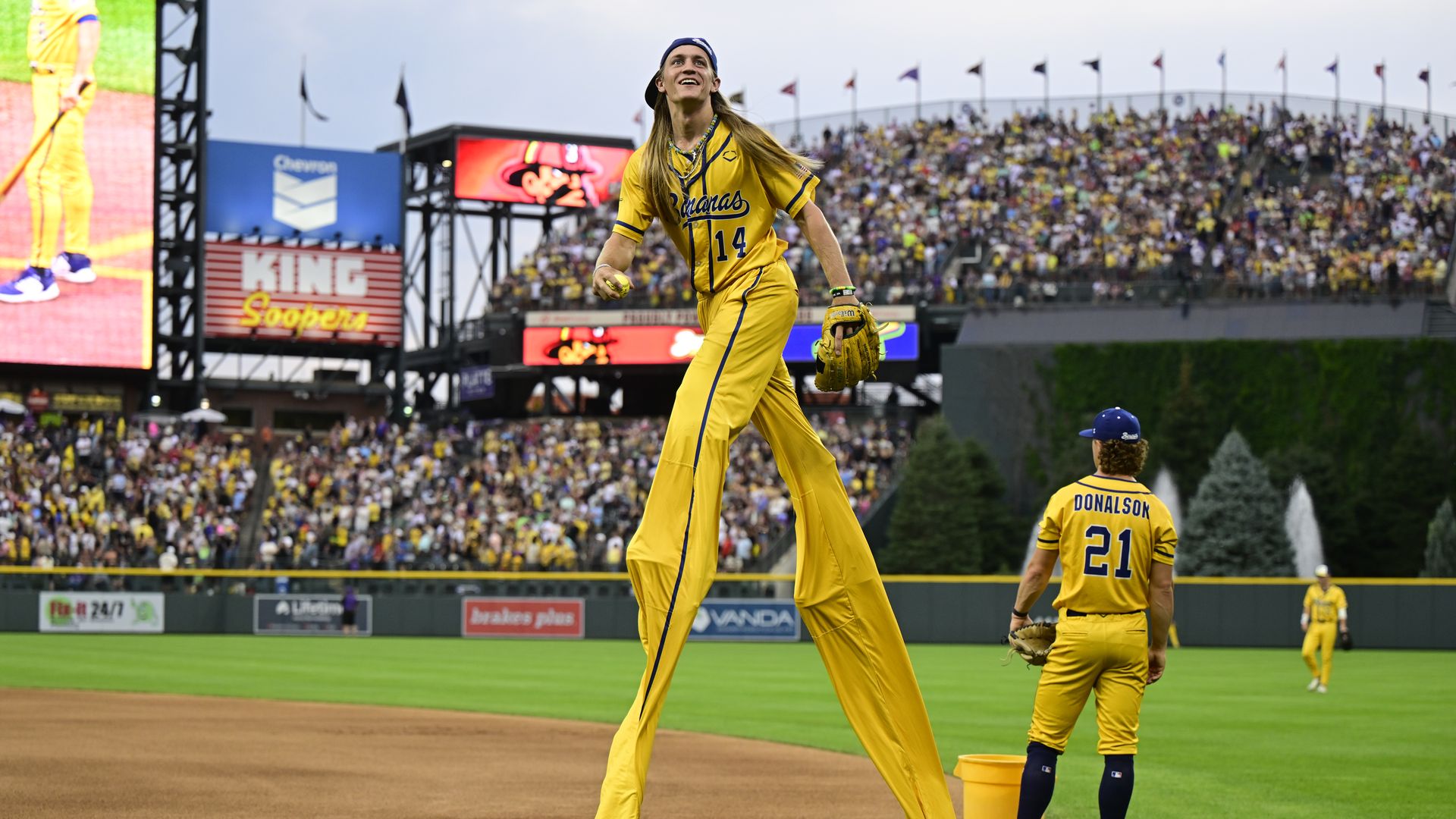 Savannah Bananas player Dakota Albritton looks for a fan to throw a ball too before playing The Firefighters at Coors Field in Denver, Colorado, on Saturday, August 09, 2025. 