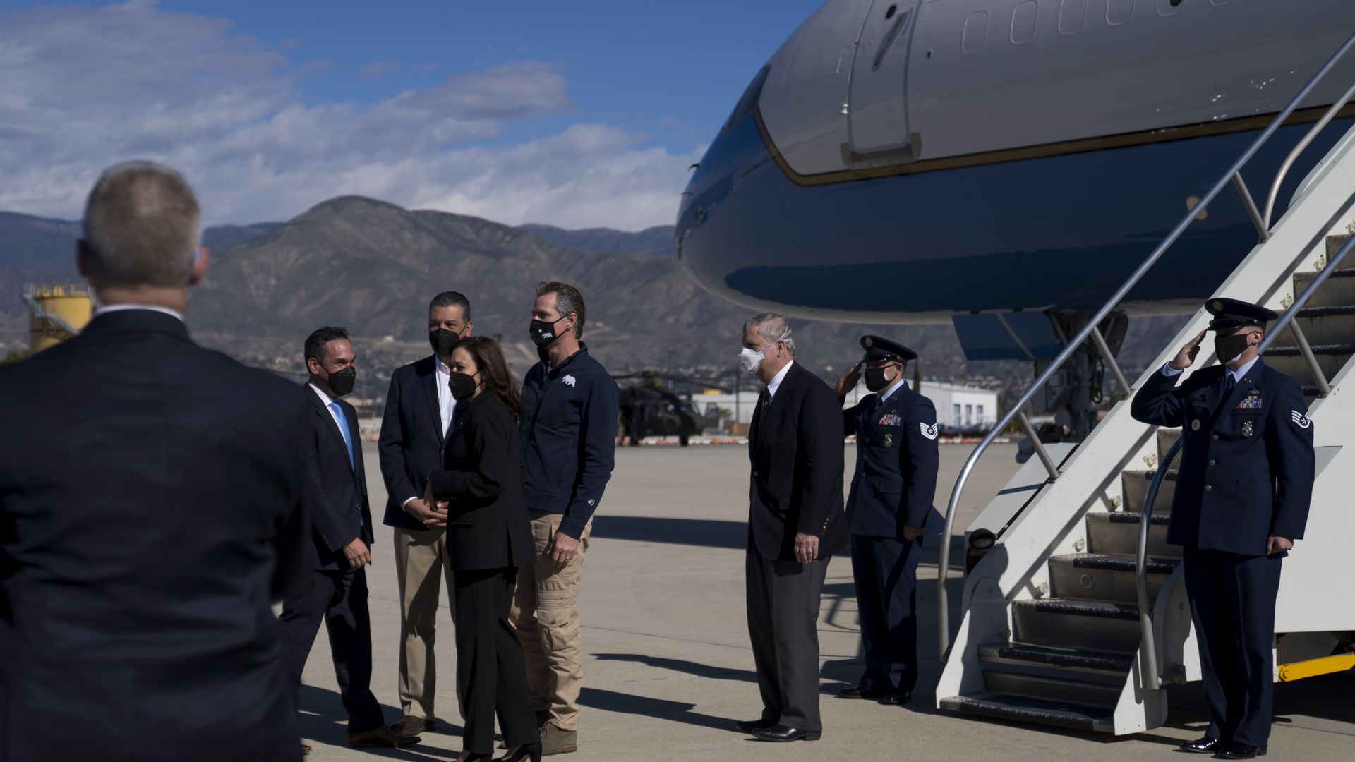 Vice President Kamala Harris, third left, is greeted by Representative Pete Aguilar.