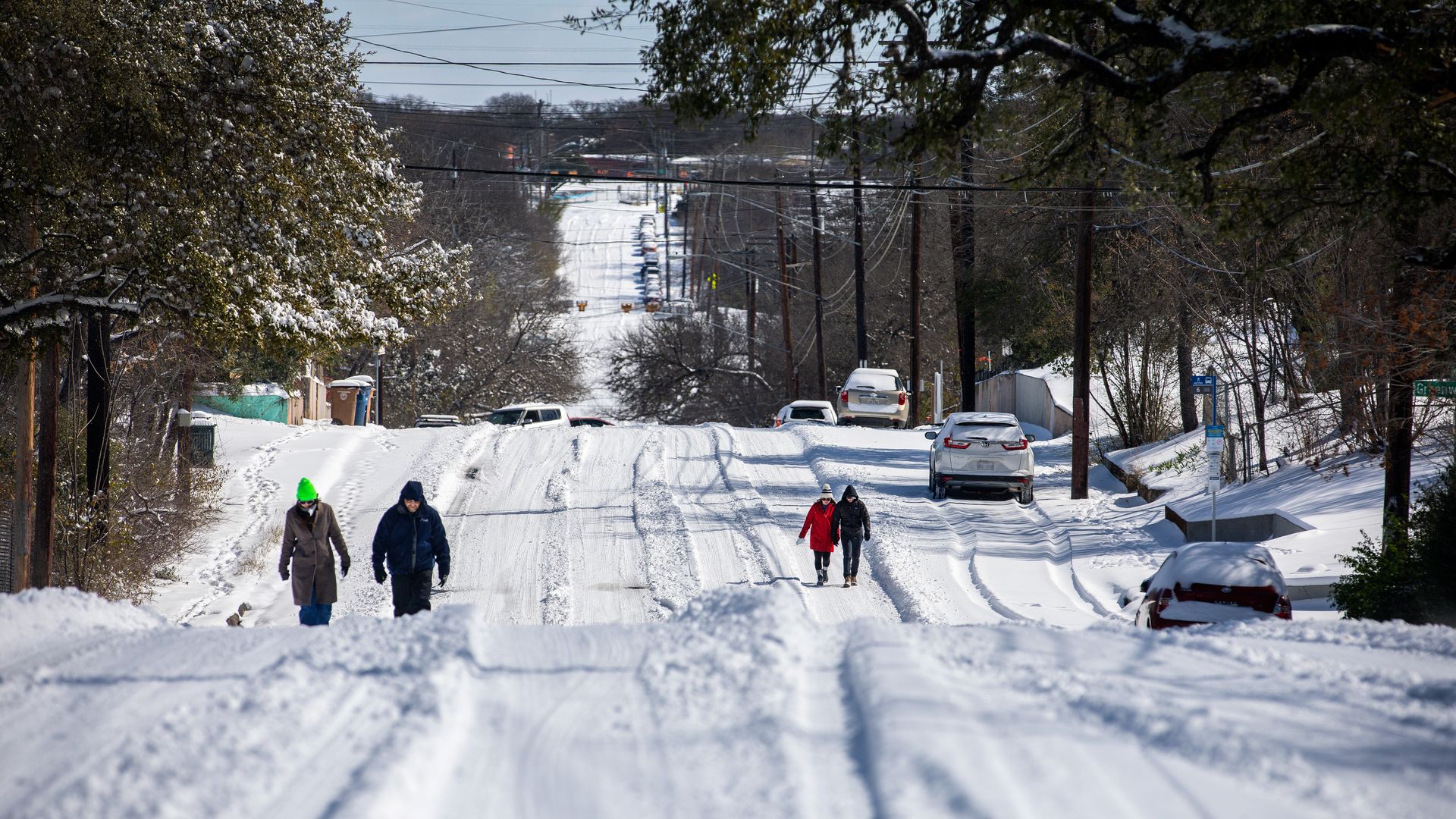 People walk through the snow during Winter Storm Uri