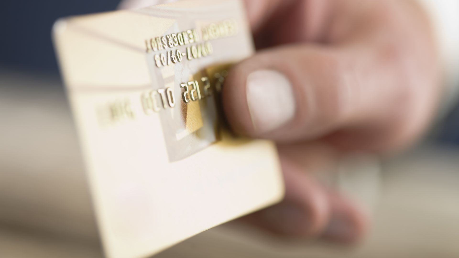 A woman holding a credit card