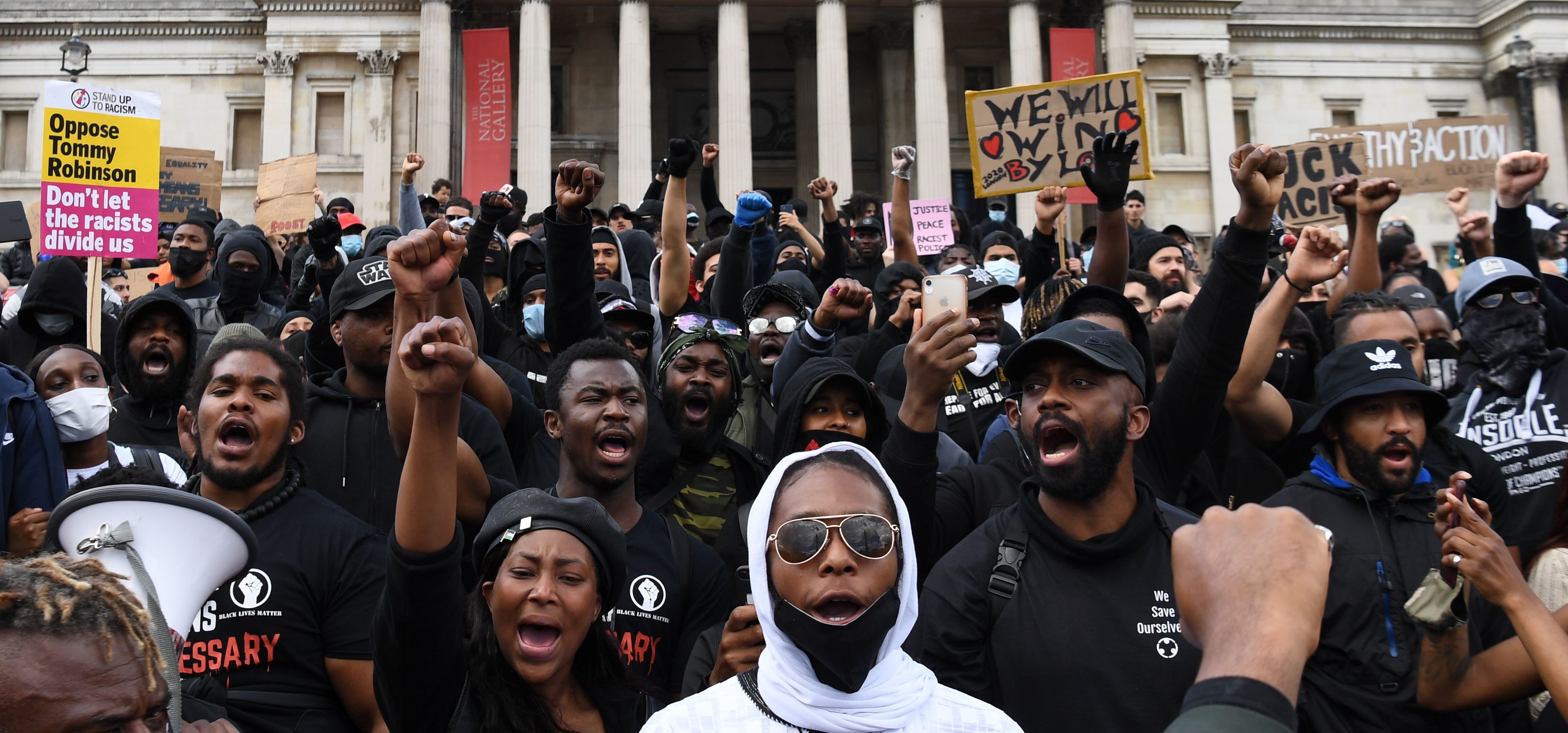 A crowd of people stand outside the National Gallery