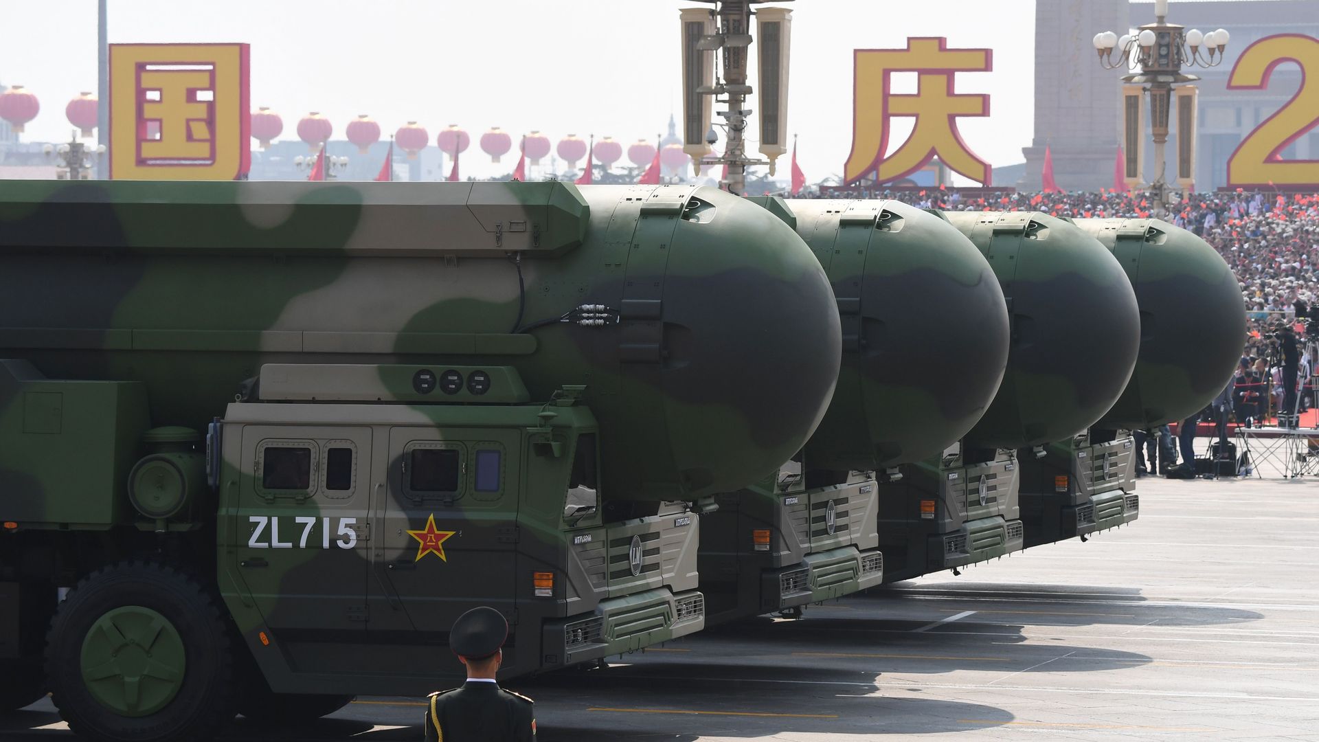 DF-41 nuclear-capable ICBMs are paraded in China. A soldier can be seen in the foreground.