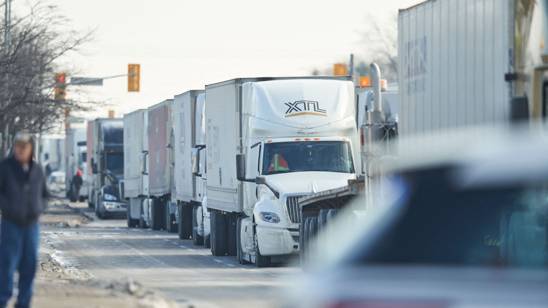 Photo of a line of trucks waiting on a road