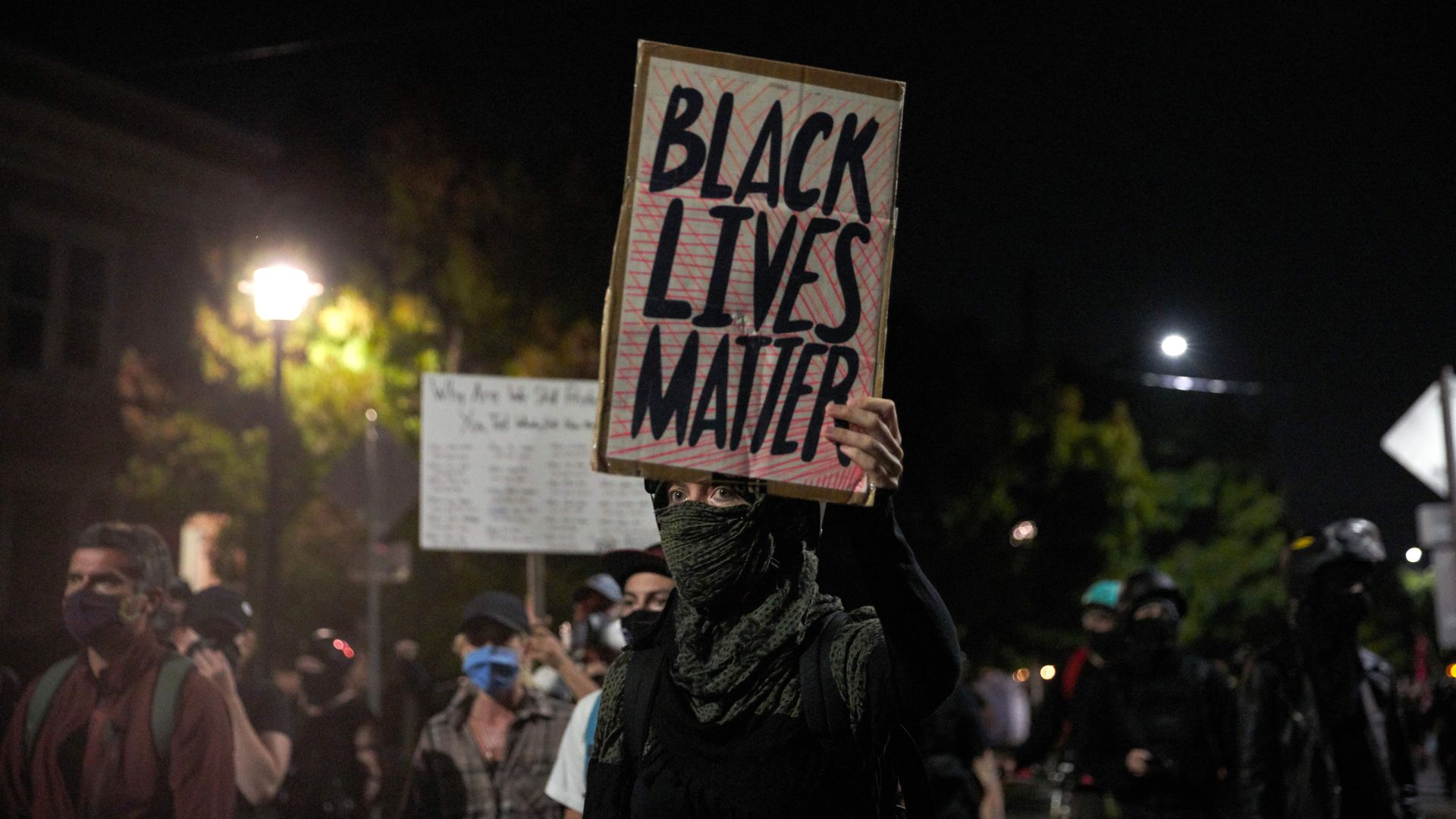 A protestor holds a 'Black Lives Matter' sign during a march to the Police Union building in Portland, Oregon, on September 4