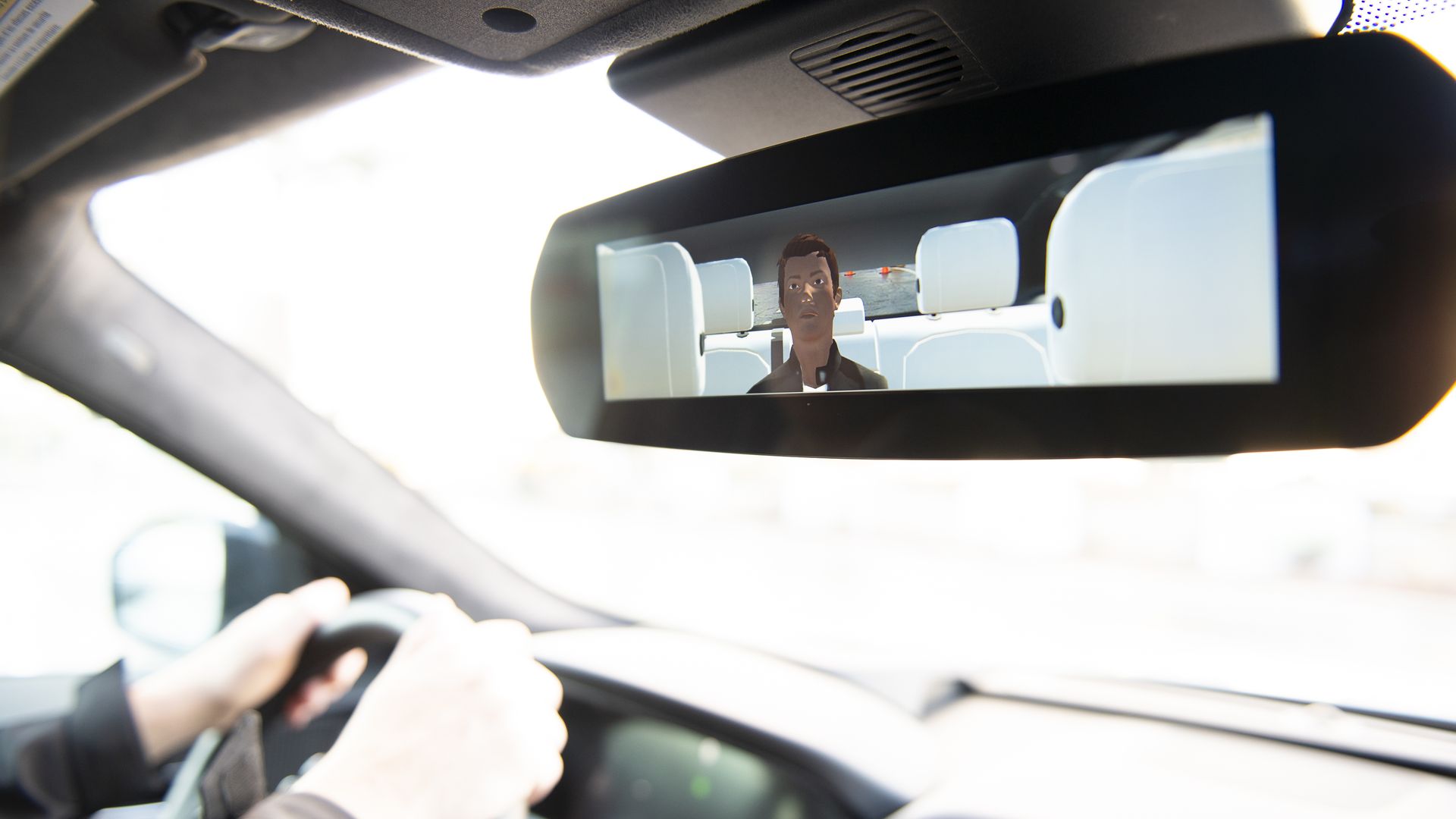 Image of virtual reality avatar in the back seat of a car.