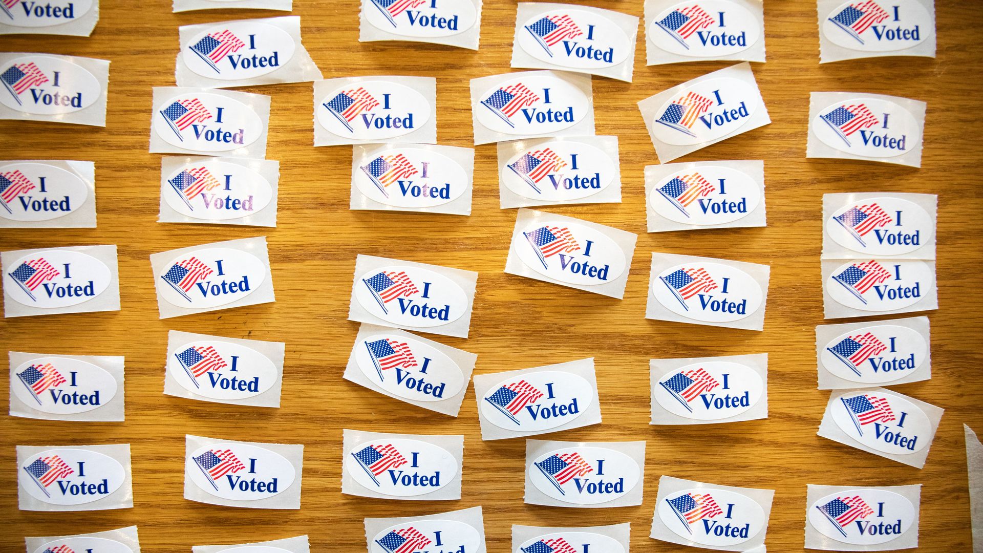 "I Voted" stickers cover a table at a polling station.