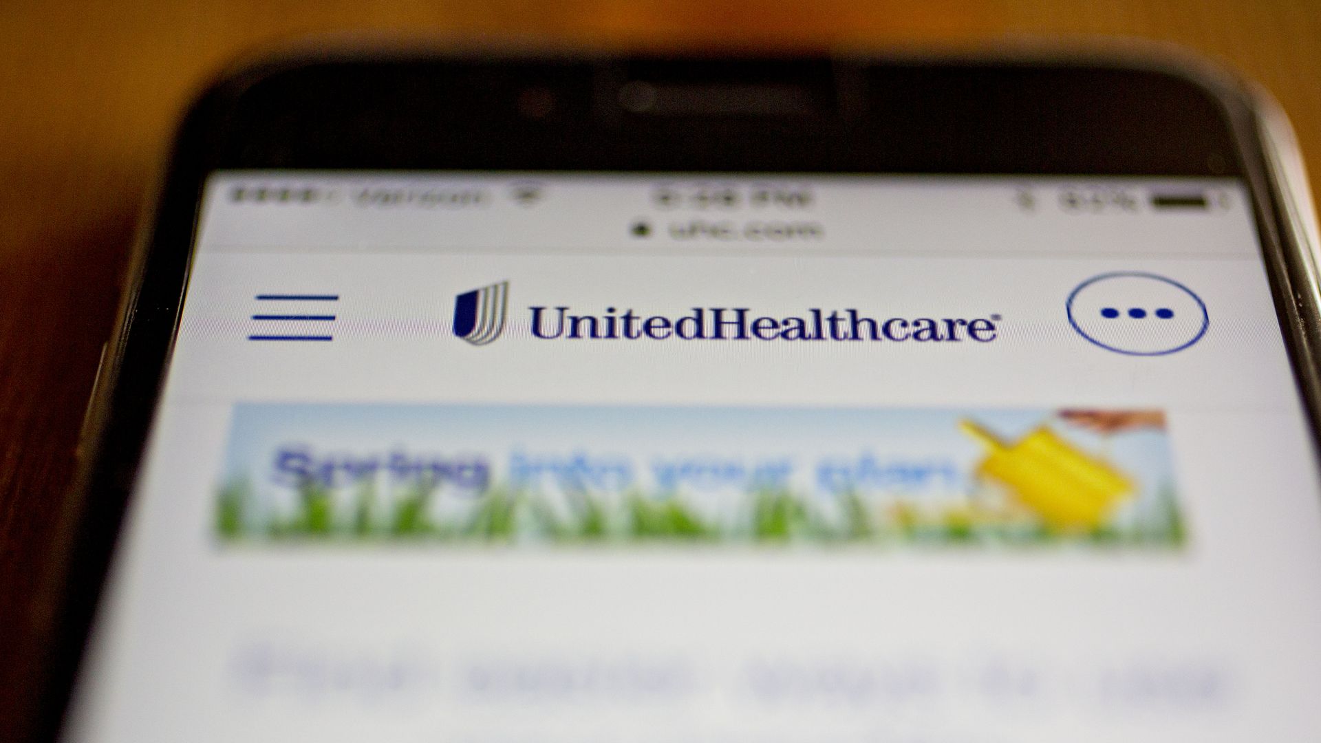 The UnitedHealthcare logo and website on a smartphone.