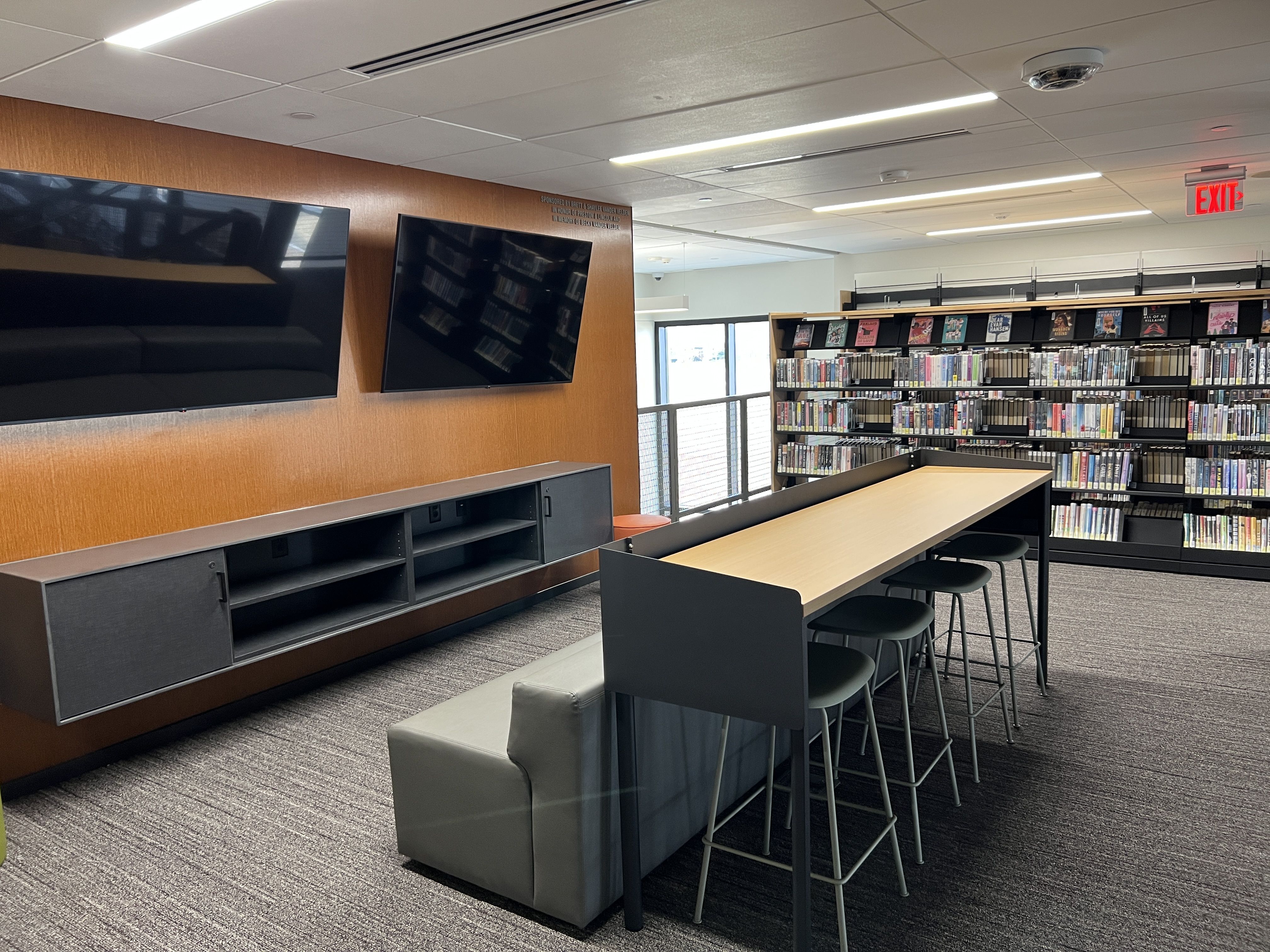 teen video game center with desks and monitors