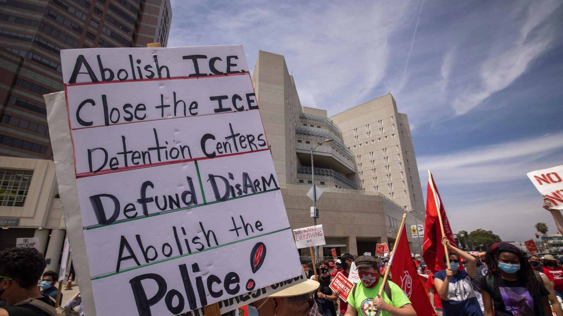 People protesting ICE pass The Metropolitan Detention Center, Los Angeles, where many undocumented immigrants are held in custody