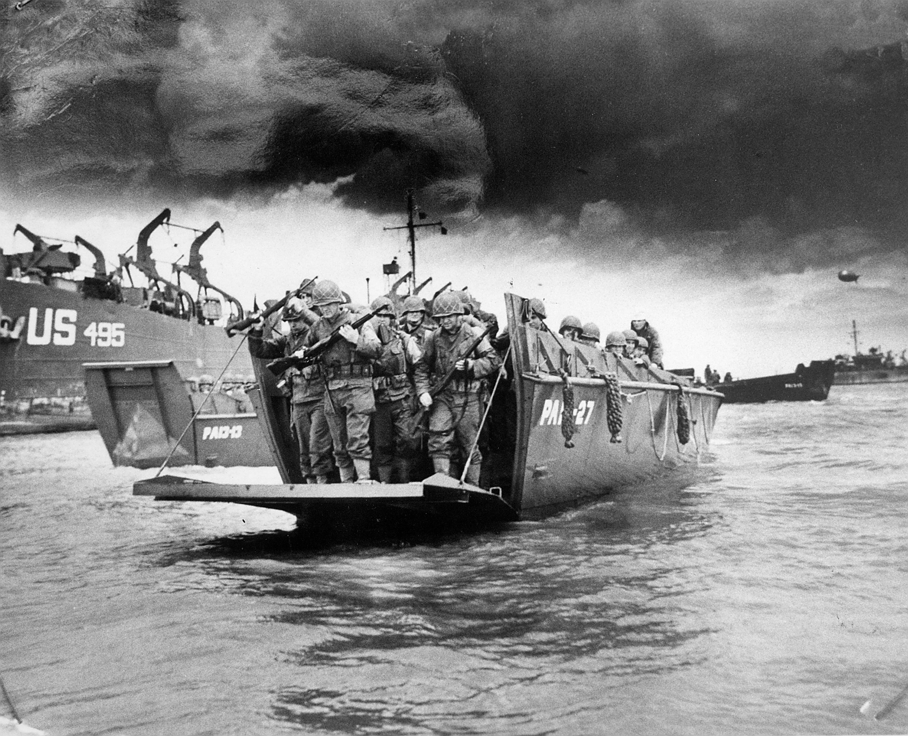 Image shows a black and white photo of soldiers in a Higgins boat.