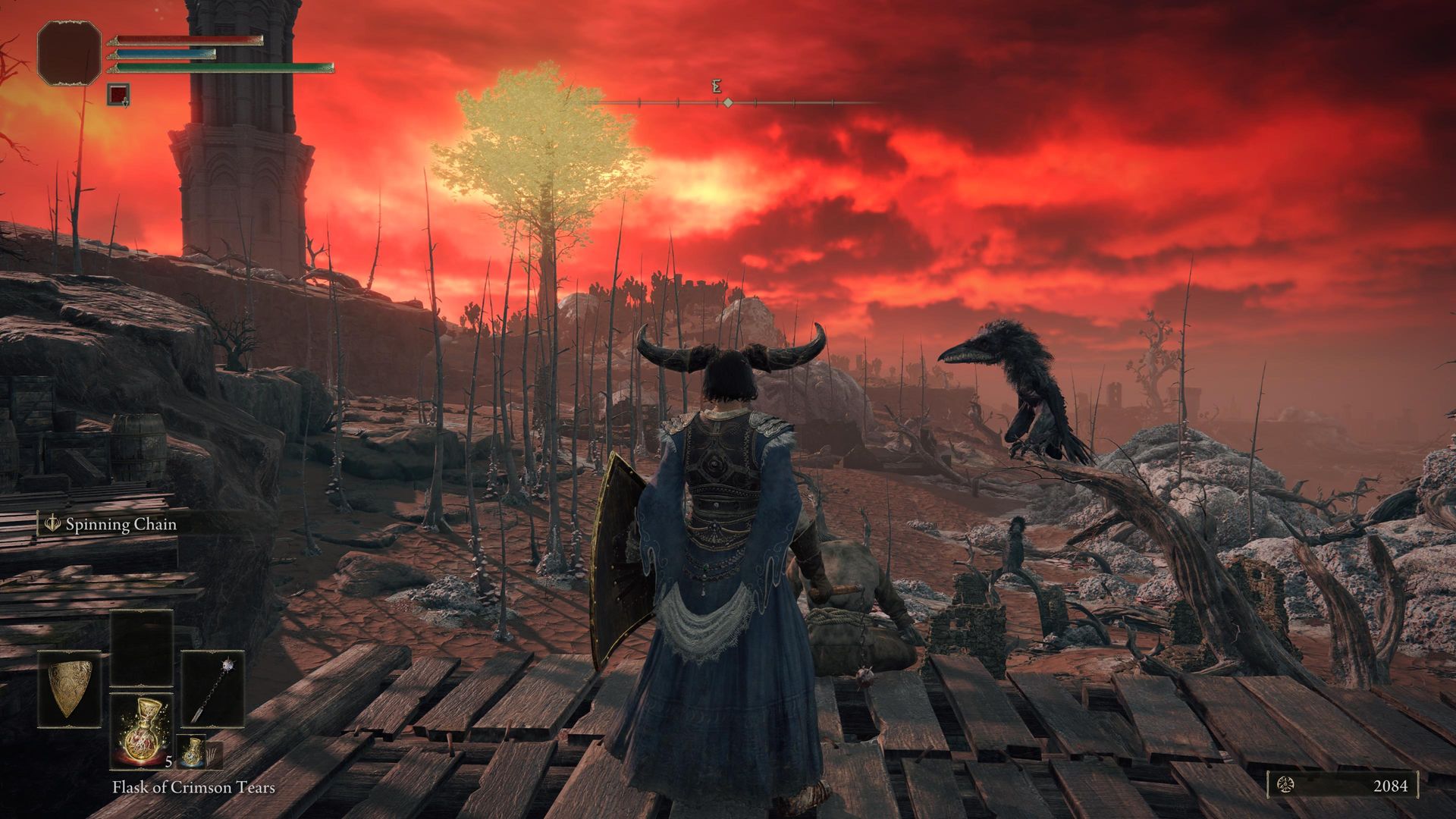 Video game screenshot of an armored knight with his back to the camera, looking at a red sky