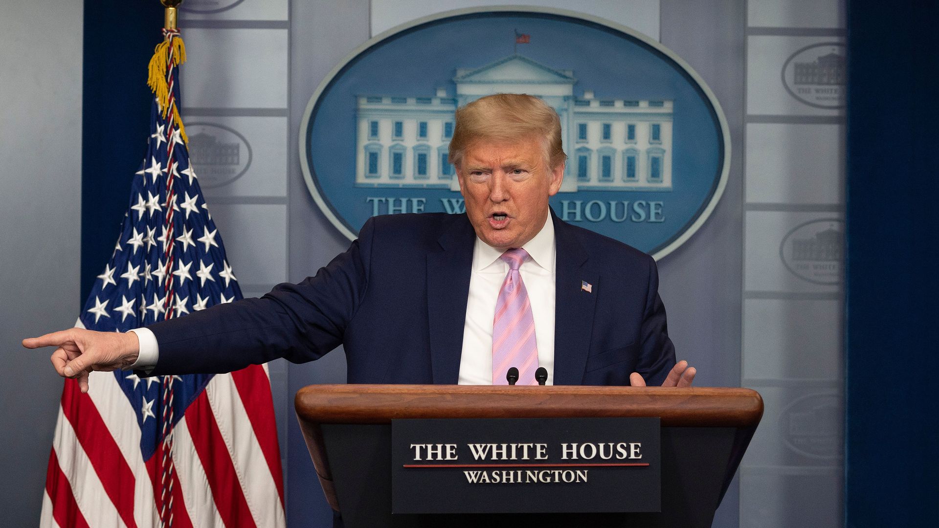 In this image, Trump stands behind a podium at the White House
