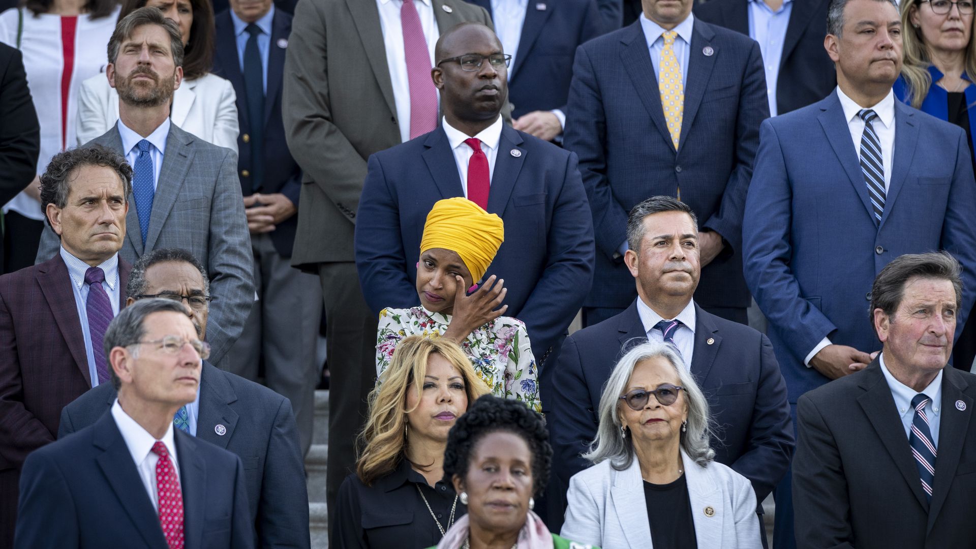 Rep. Ilhan Omar (D-MN) tears up as members of Congress hold a moment of silence for the 600,000 American lives lost to COVID-19, on the steps of the U.S. Capitol on June 14