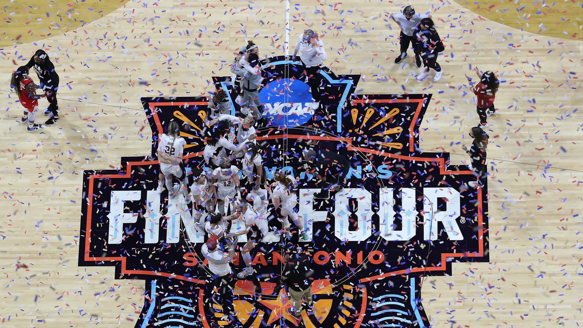 People celebrating with confetti inside the Alamodome during the 2021 NCAA Women's Basketball Tournament 