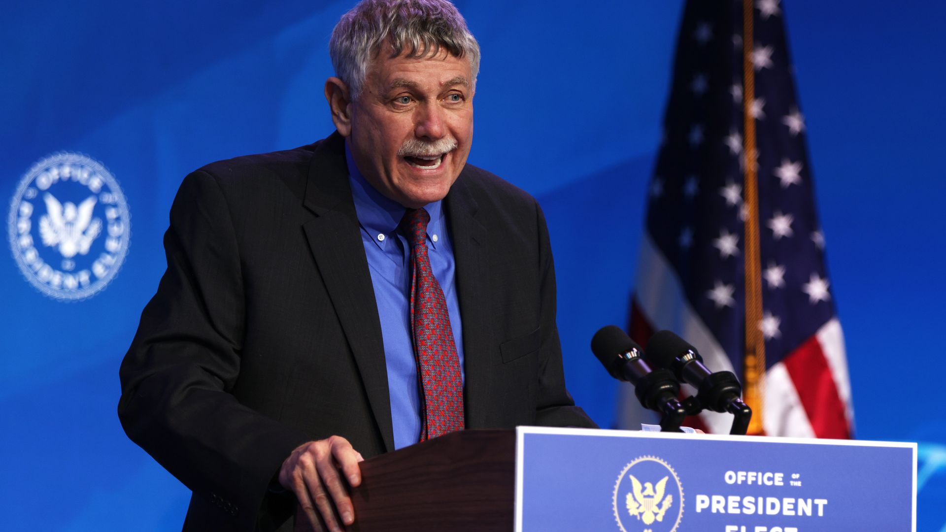 Photo of Eric Lander speaking from a podium