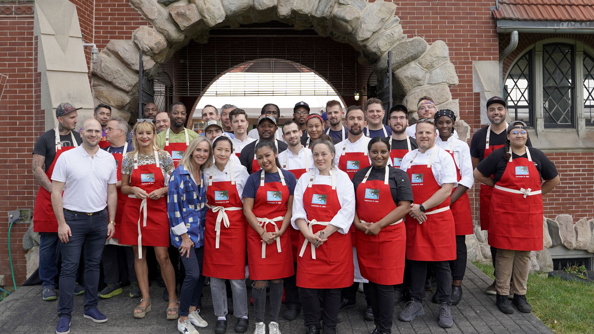 Photo of chefs in aprons posing for the camera. 