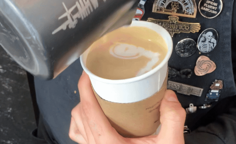 GIF of a barista pouring milk into a cup 