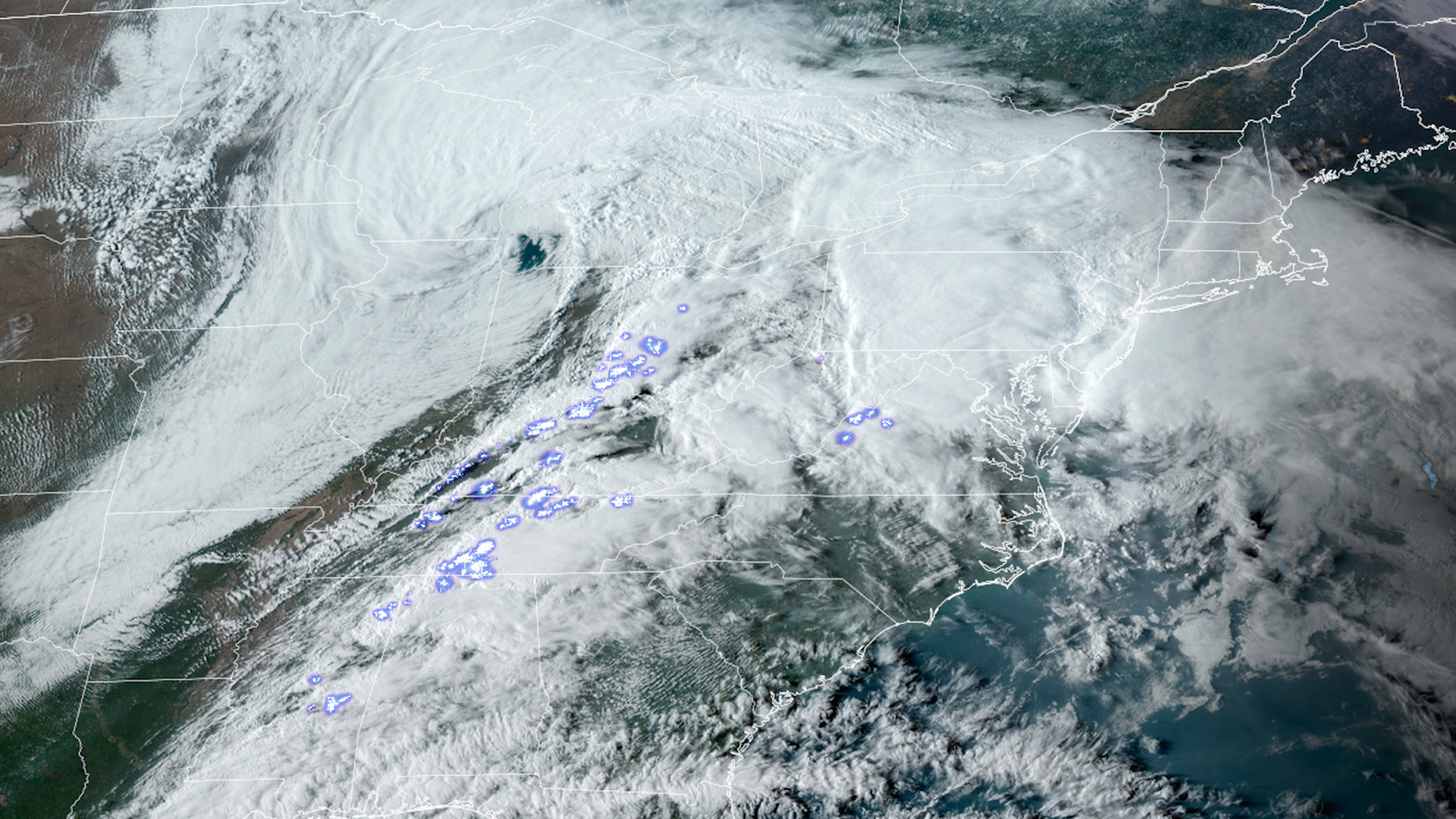 Satellite image of clouds and flashes showing lightning within them on April 2 across the U.S.