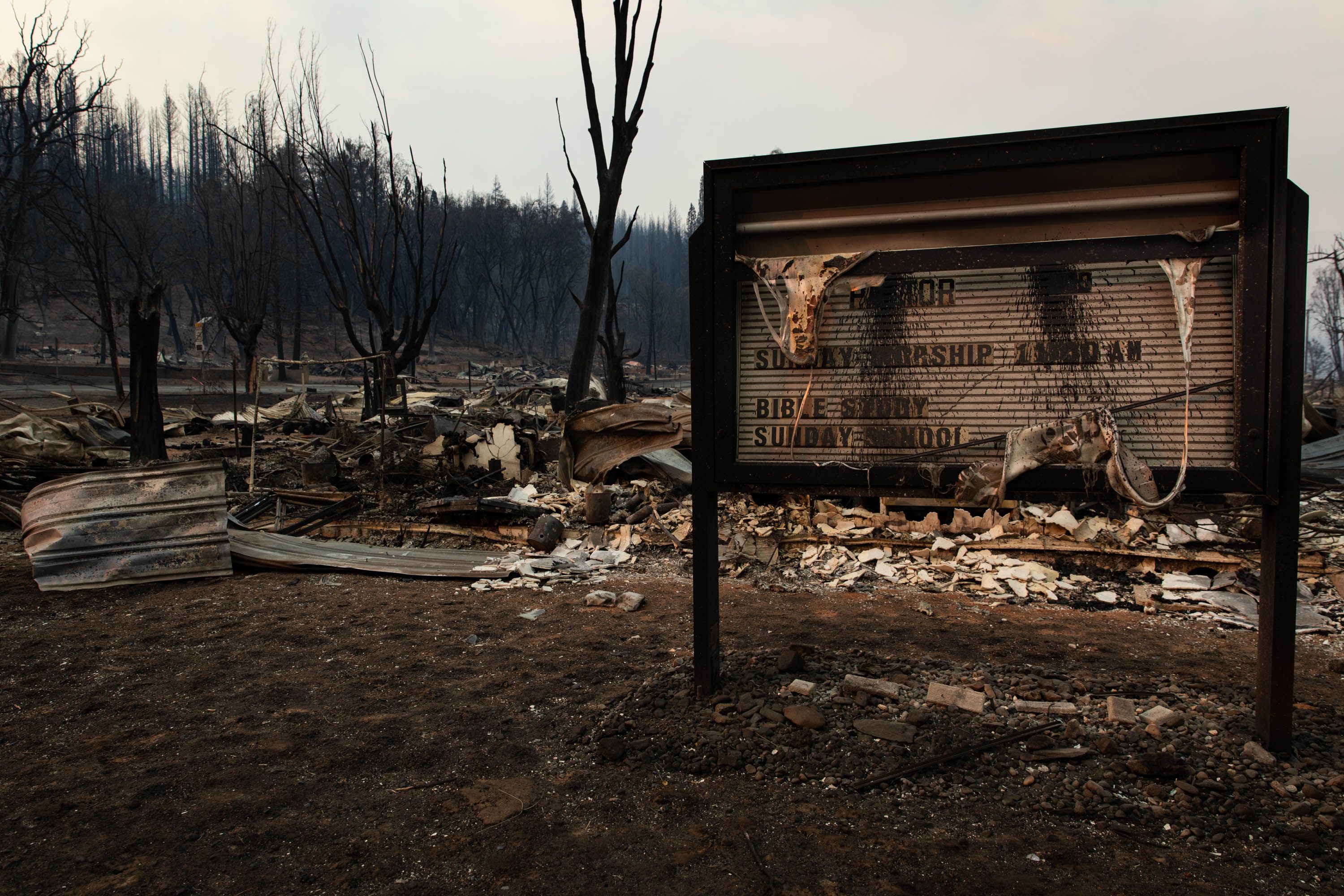 The remnants of a church sign near the burned remains of the church building in California 