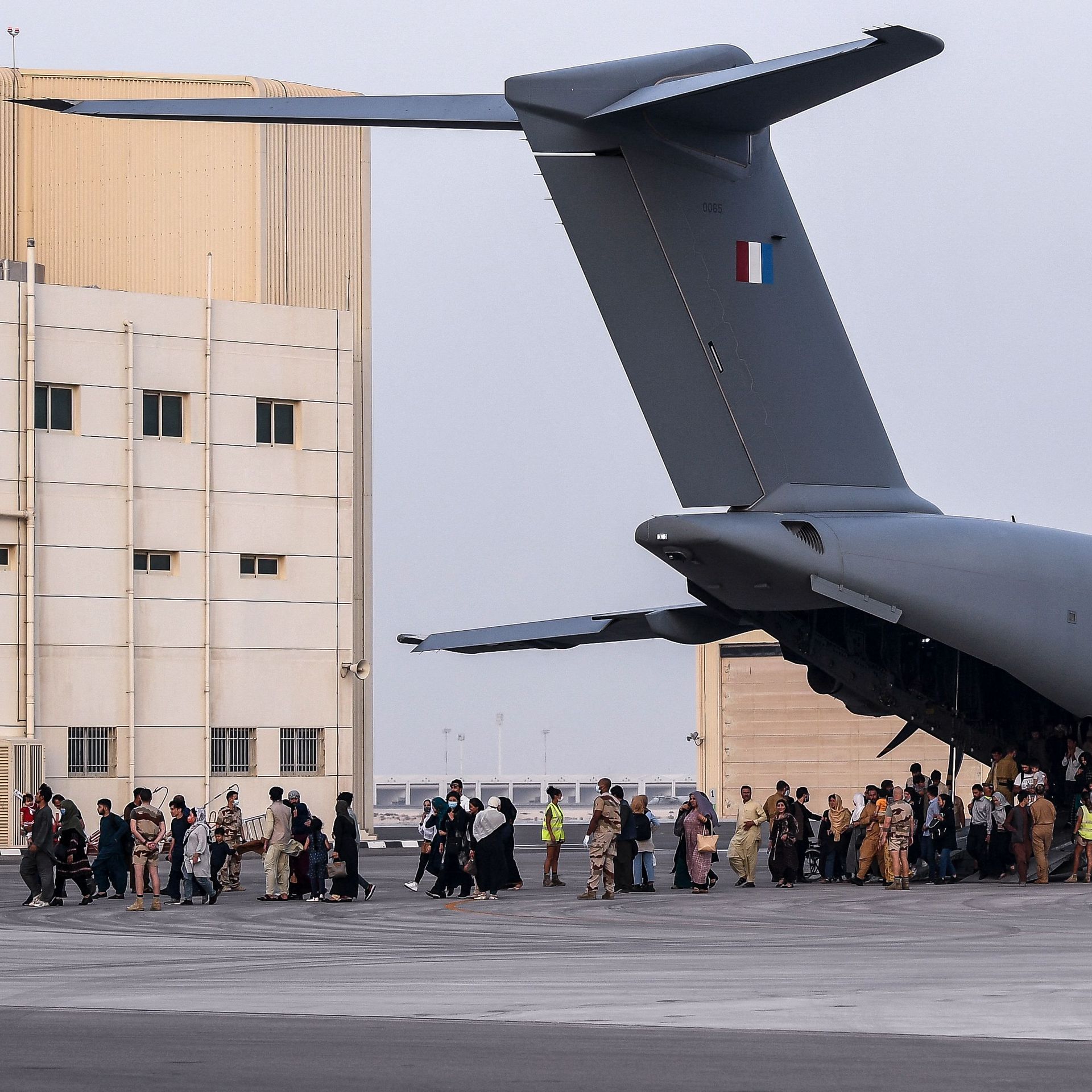 People disembark from a Airbus A400M military transport aircraft at the French military air base 104 of Al Dhafra, near Abu Dhabi, on August 23, after being evacuated from Kabul