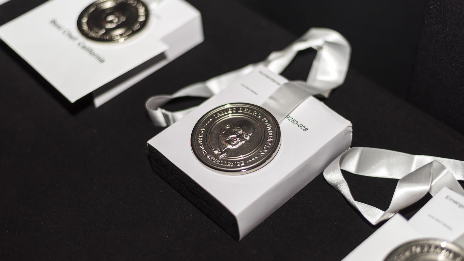 James Beard awards displayed on a black surface. 