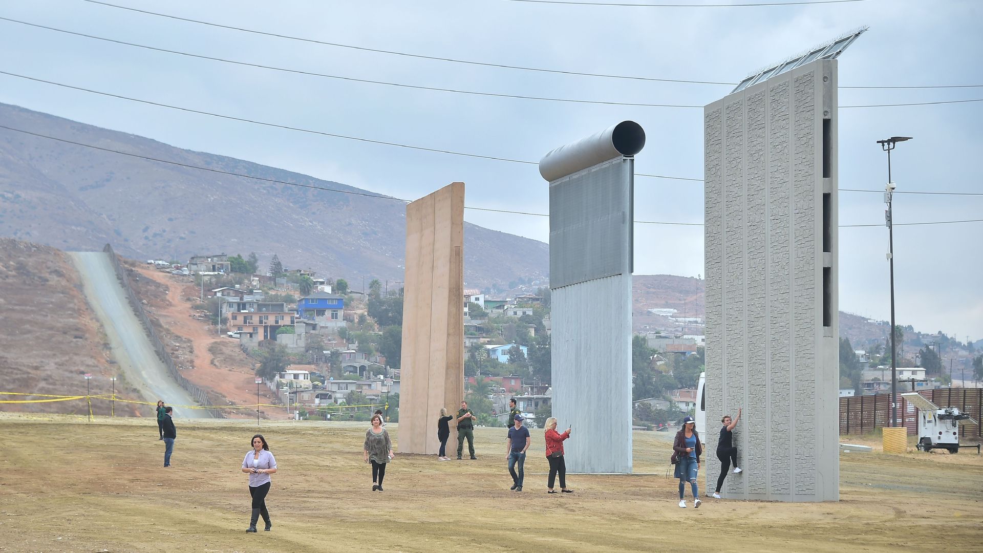 Local city officials visit prototypes of the proposed border wall in San Diego in November. (Frederic J. Brown/AFP/Getty Images)