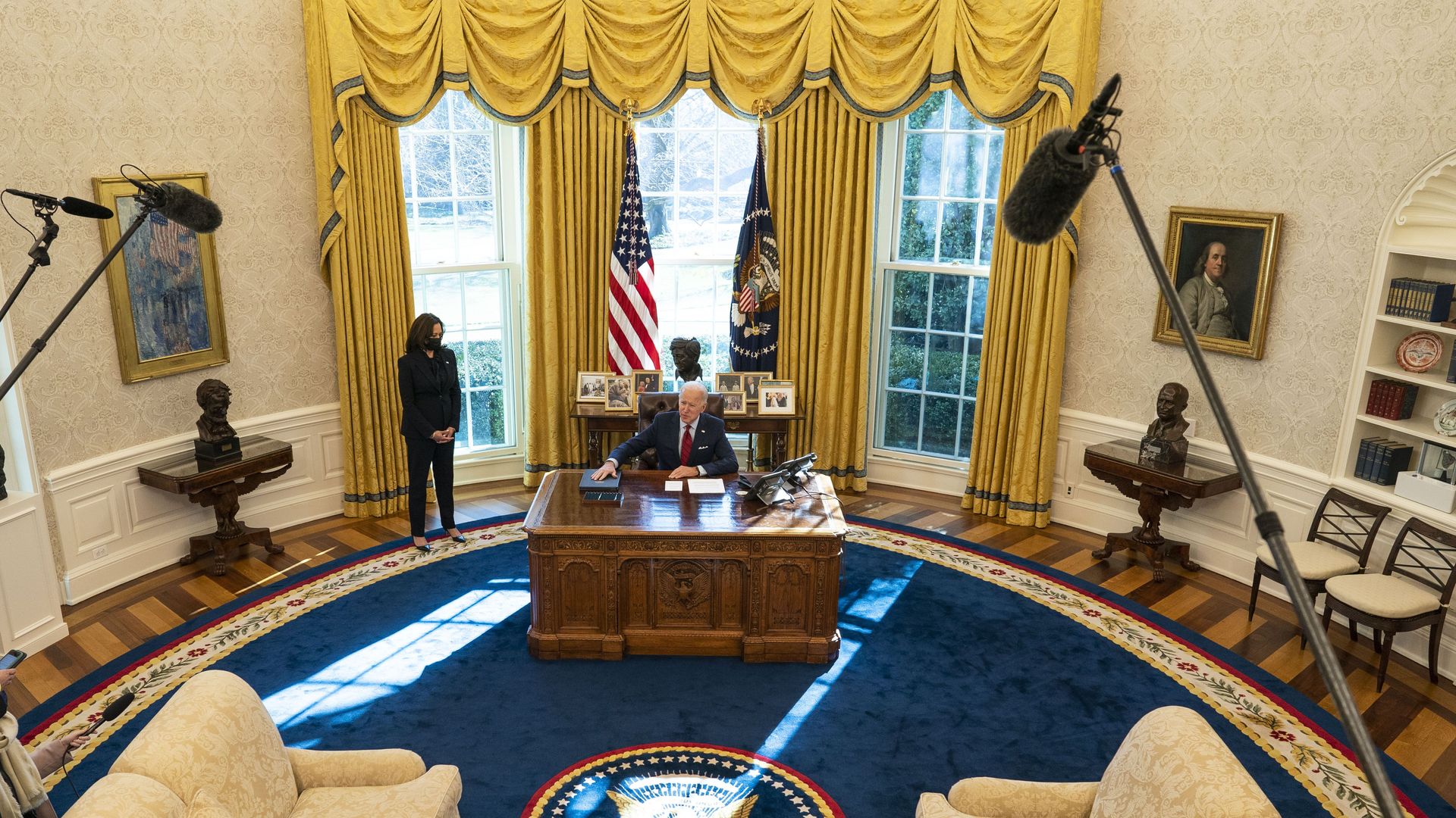 Joe Biden at the resolute desk with kamala harris in the oval office.