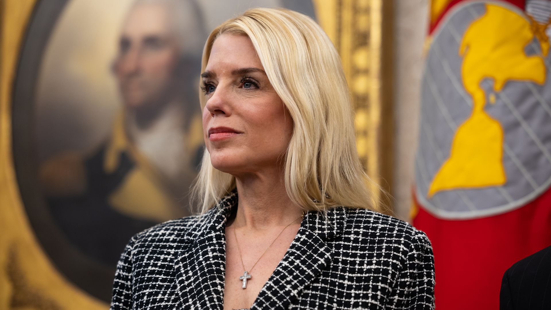 Photo of a woman posing for the camera at a press conference. 
