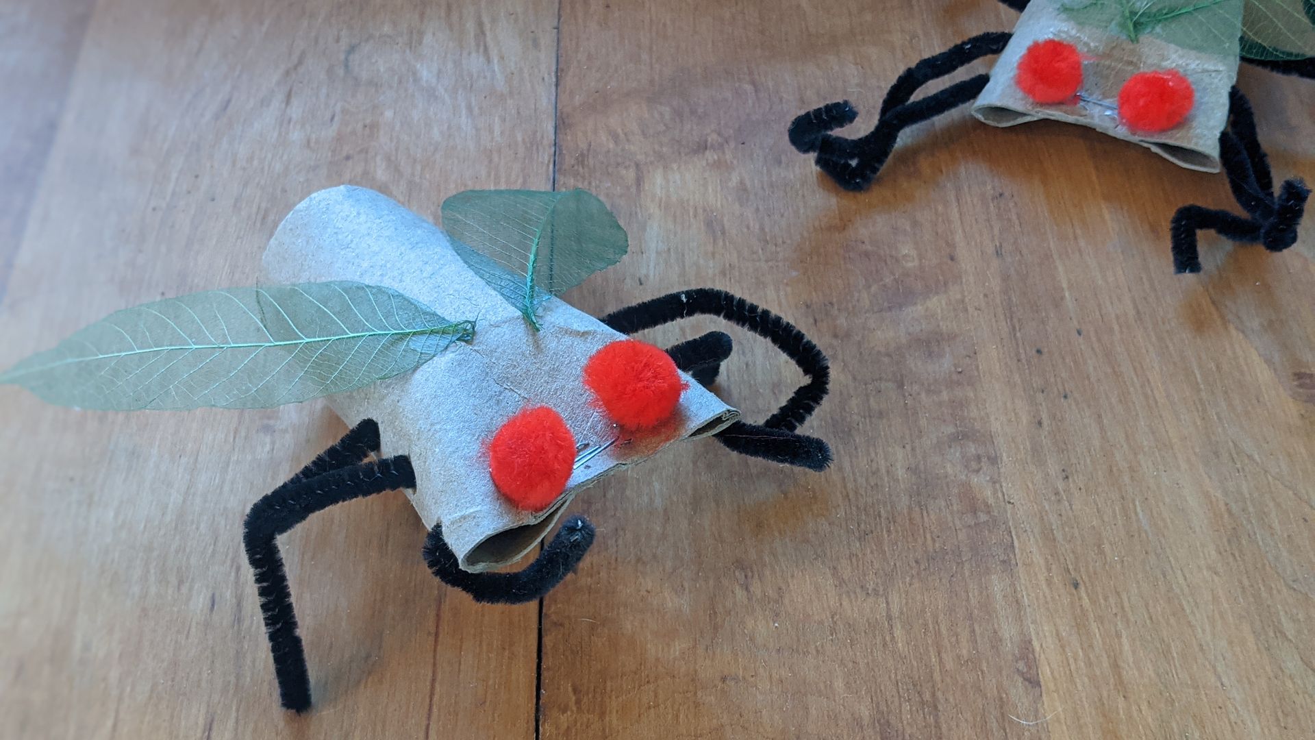 Cicadas made of paper tubes and pipe cleaners