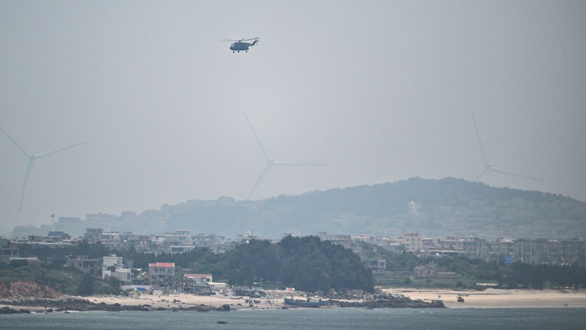 Chinese military helicopters fly over Pingtan island, the closest point in China to Taiwan on May 19