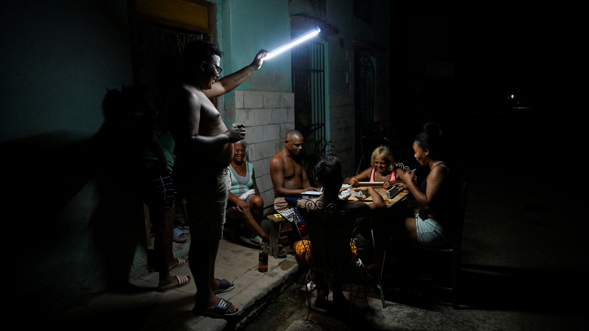 People play domino on the street during a blackout in Havana on September 10, 2025. Cubans were in despair on September 10, 2025, after their cash-strapped communist country plunged into its fifth nationwide power blackout in a year. (Photo by YAMIL LAGE / AFP) (Photo by YAMIL LAGE/AFP via Getty Ima