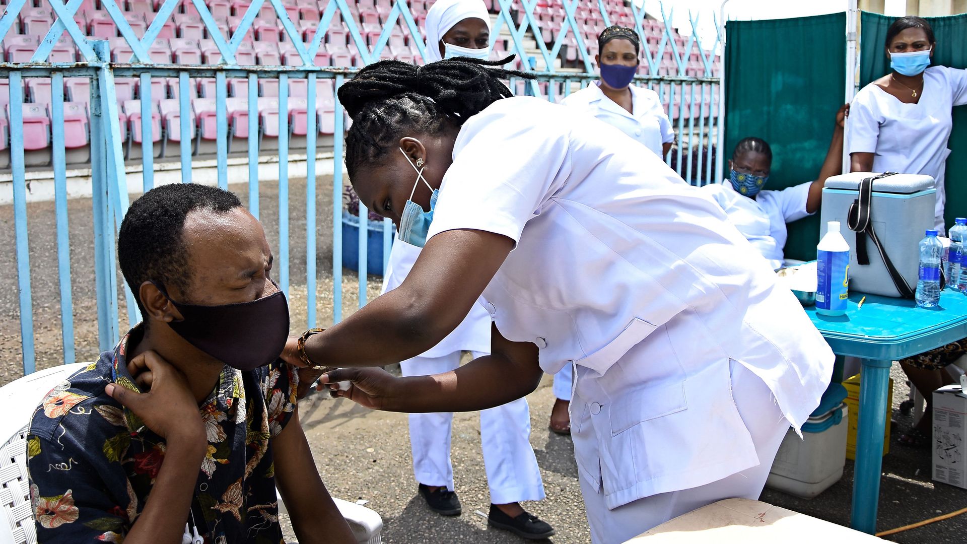 Picture of a man closing his eyes as he gets vaccinated