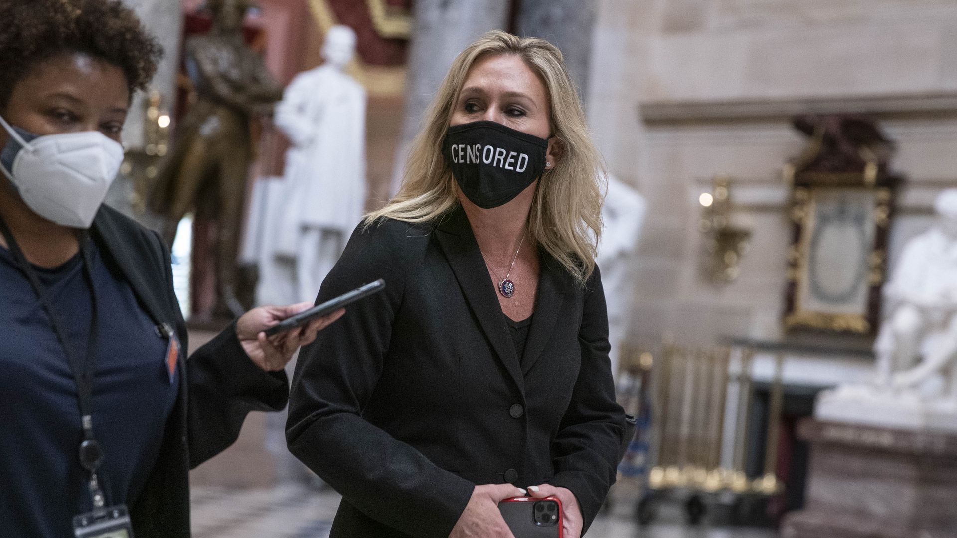 Picture of Marjorie Taylor Greene wearing a face mask that says "censored" 