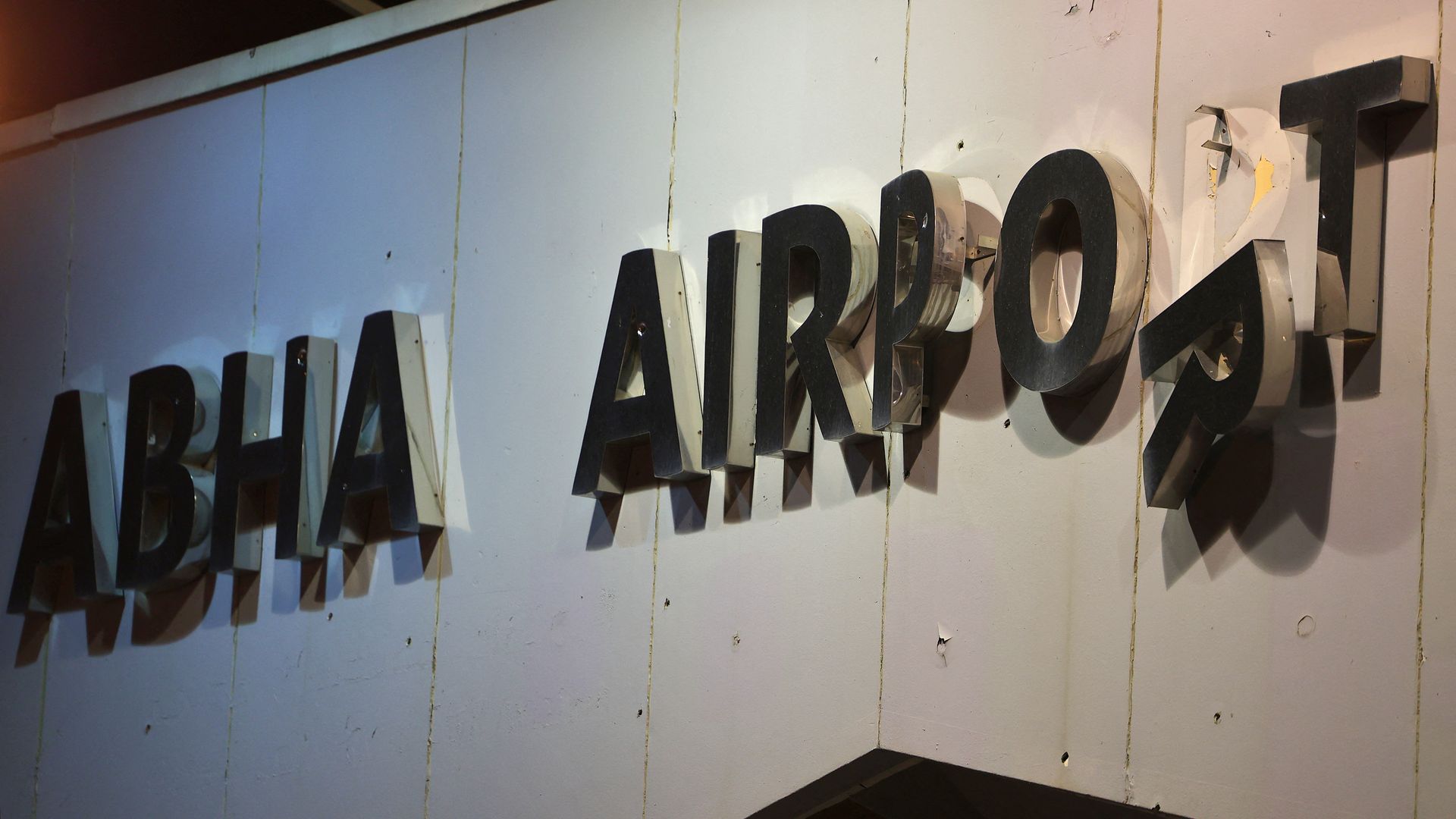 Adamaged sign at the entrance of Abha airport in the popular mountain resort of Abha in the southwest of Saudi Arabia on August 31, 2021.