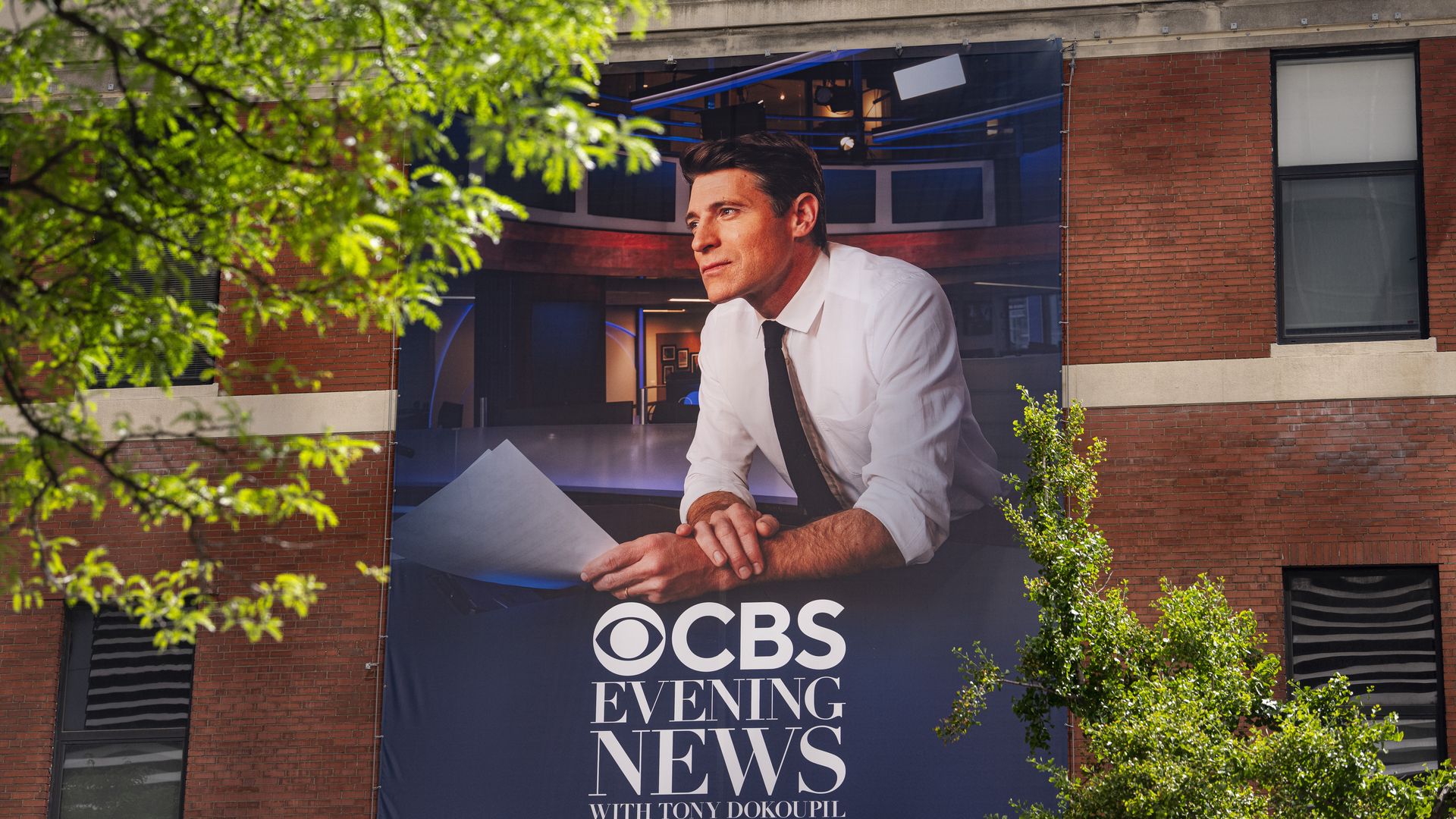Tony Dokoupil, anchor of the "CBS Evening News," is featured on a banner outside the CBS Broadcast Center in New York. Photo: Al Drago/Getty Images
