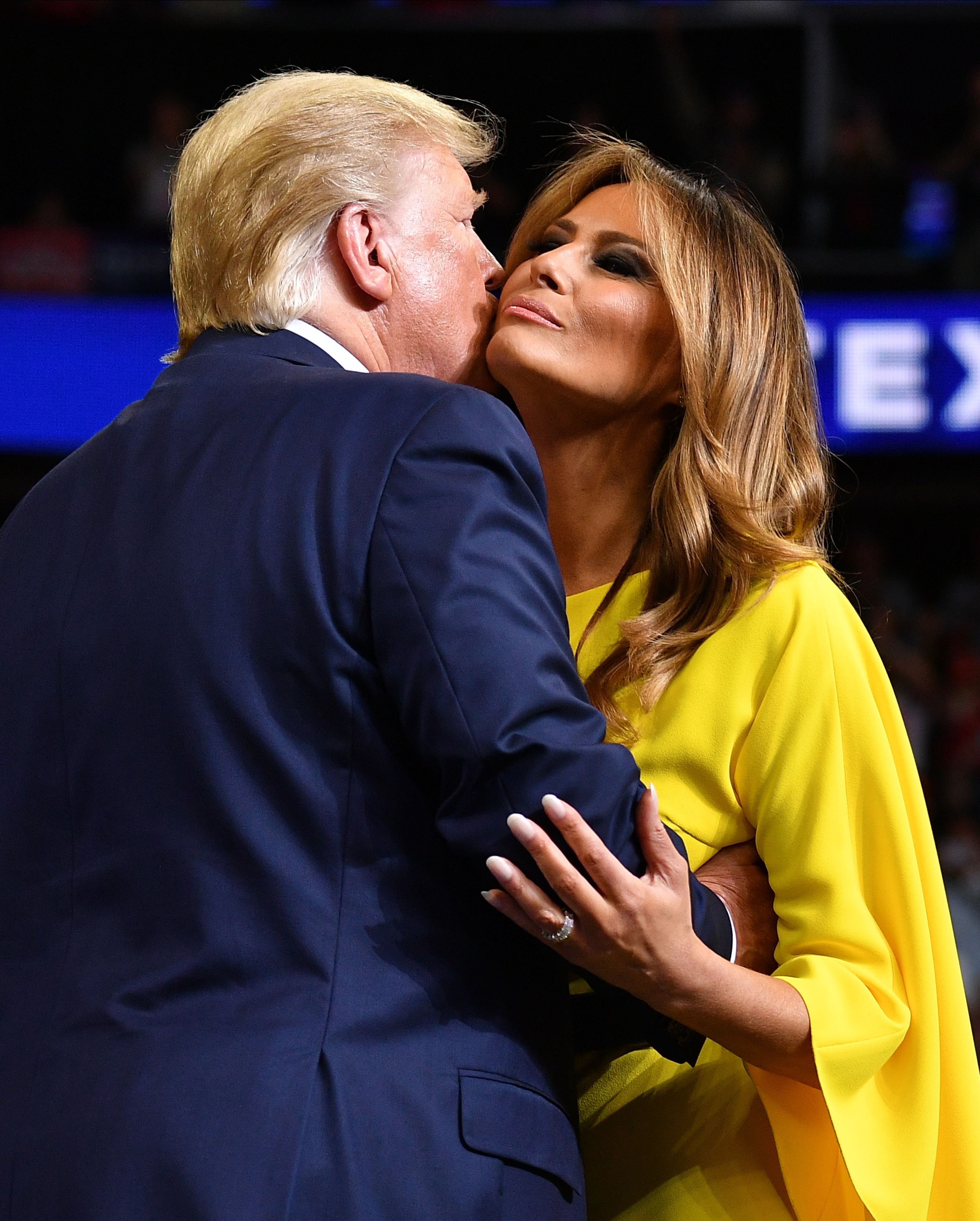 Trump and First Lady Melania Trump embrace.