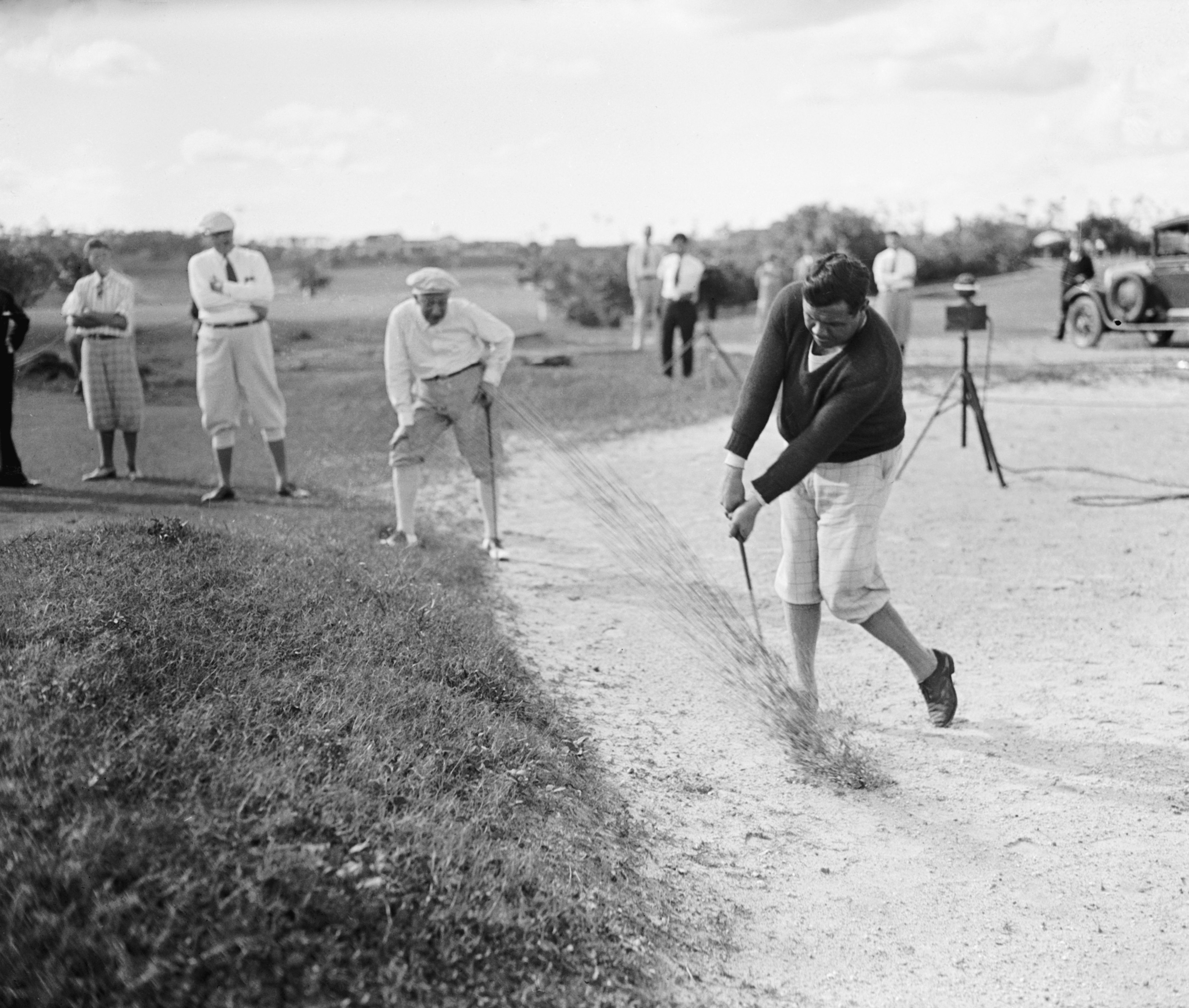 (Original Caption) Florida: Babe Ruth "Trapped." Babe Ruth, the famous ball slugger got himself into this difficult trap, during a golf match with former Governor Al Smith of New York at the Miami Biltmore Hotel Links at Coral Gables, Florida, while Smith, hand on knee, intently looked on. again, th