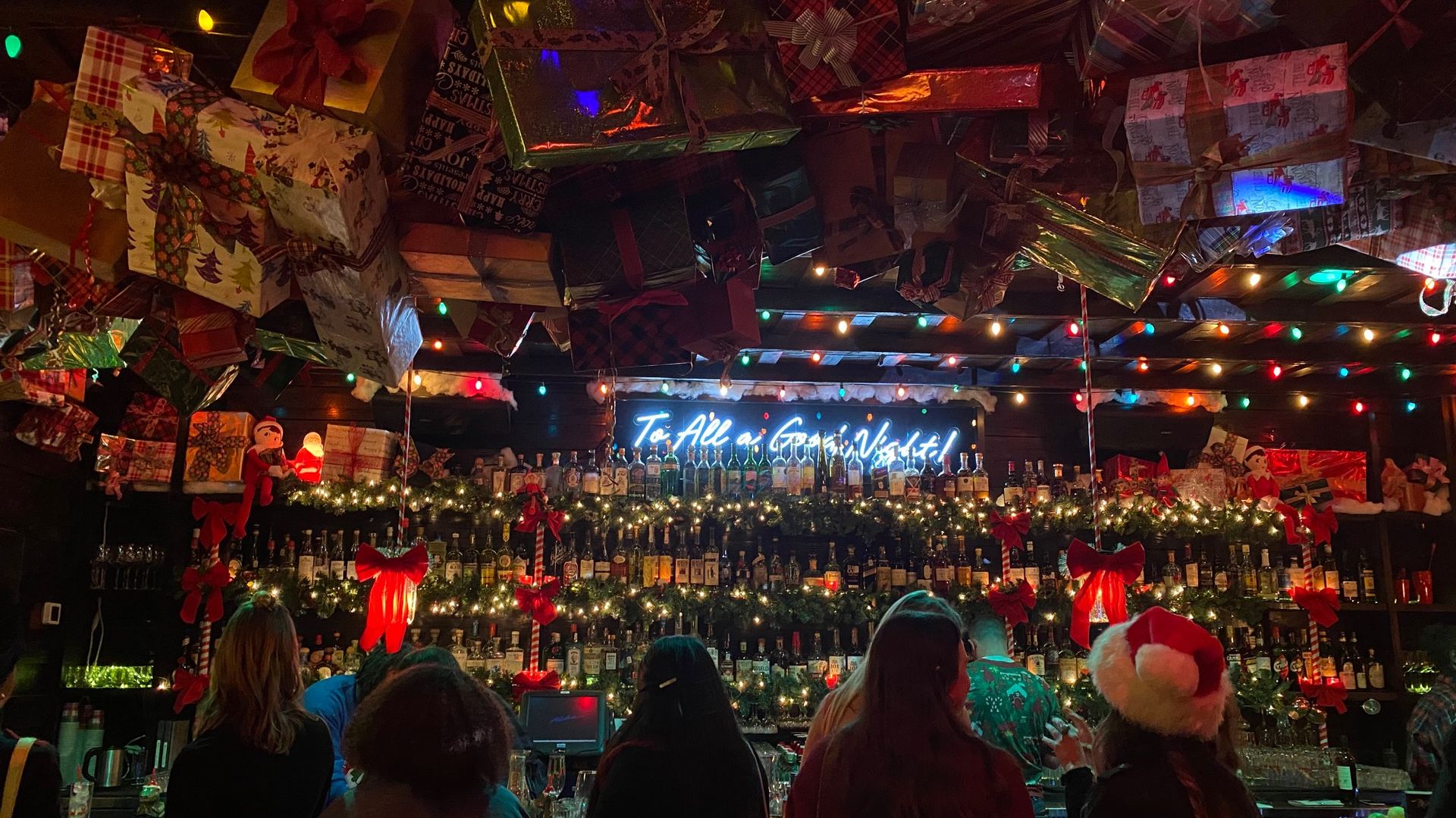 A photo of Miracle on 5th Street visitors standing at the bar.