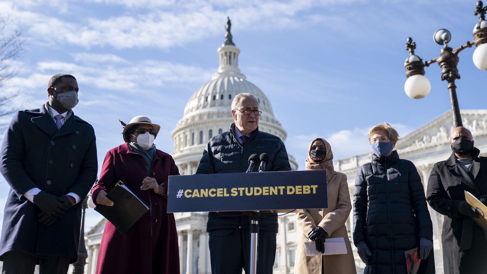 Senate Majority Leader Chuck Schumer is seen speaking before the Capitol during a news conference about canceling student debt.