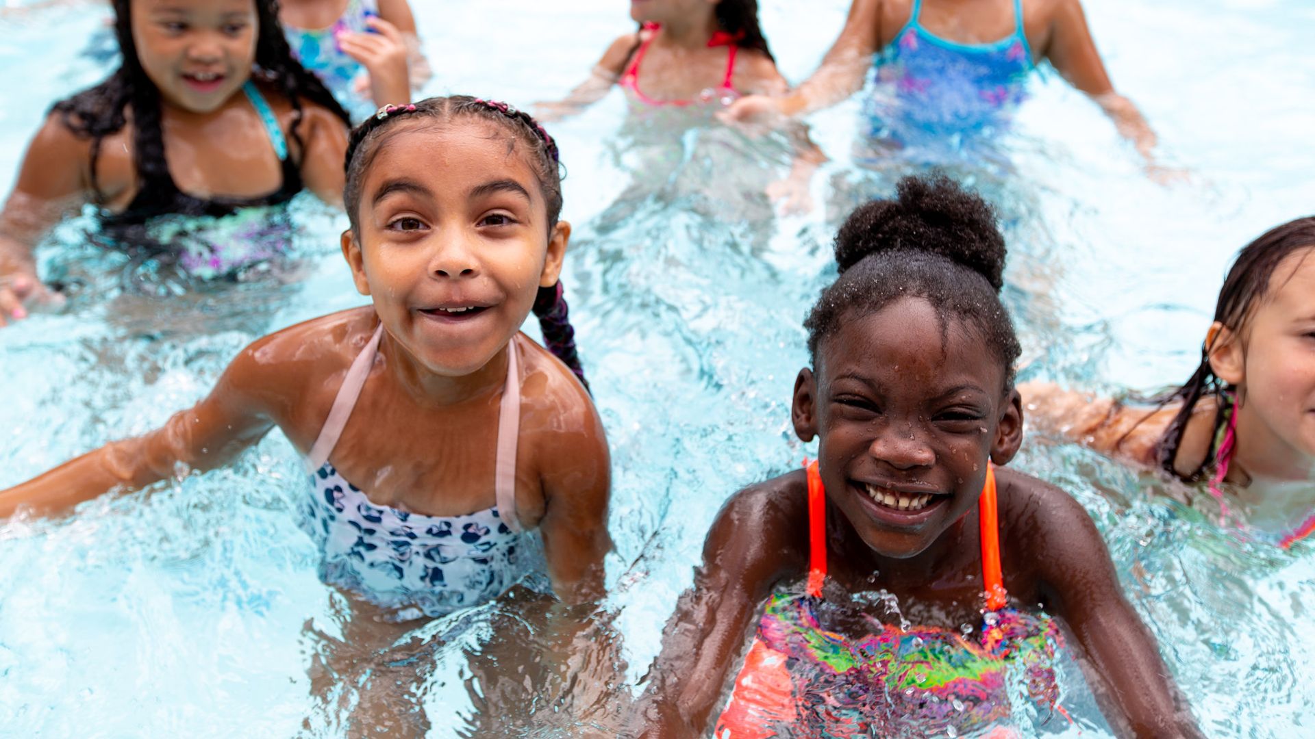Children playing in a pool. 