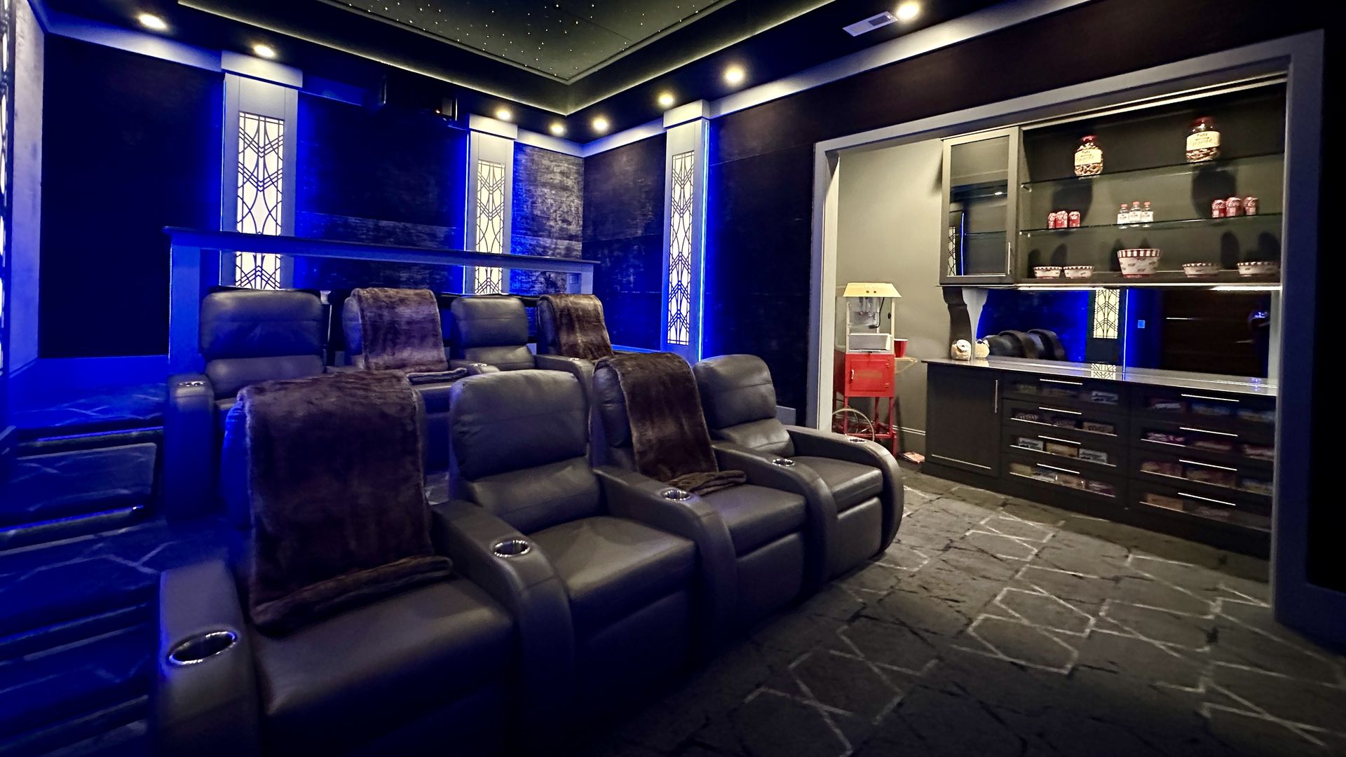 In-home movie theater with recliner chairs and a popcorn machine