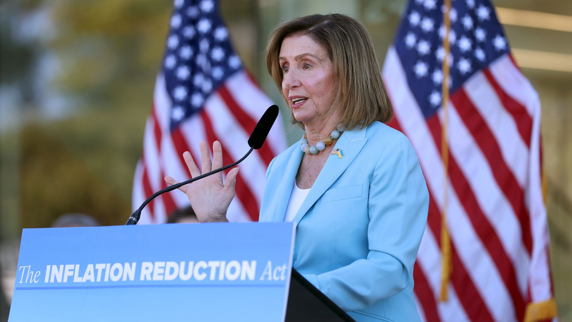 Photo of Nancy Pelosi speaking from a podium