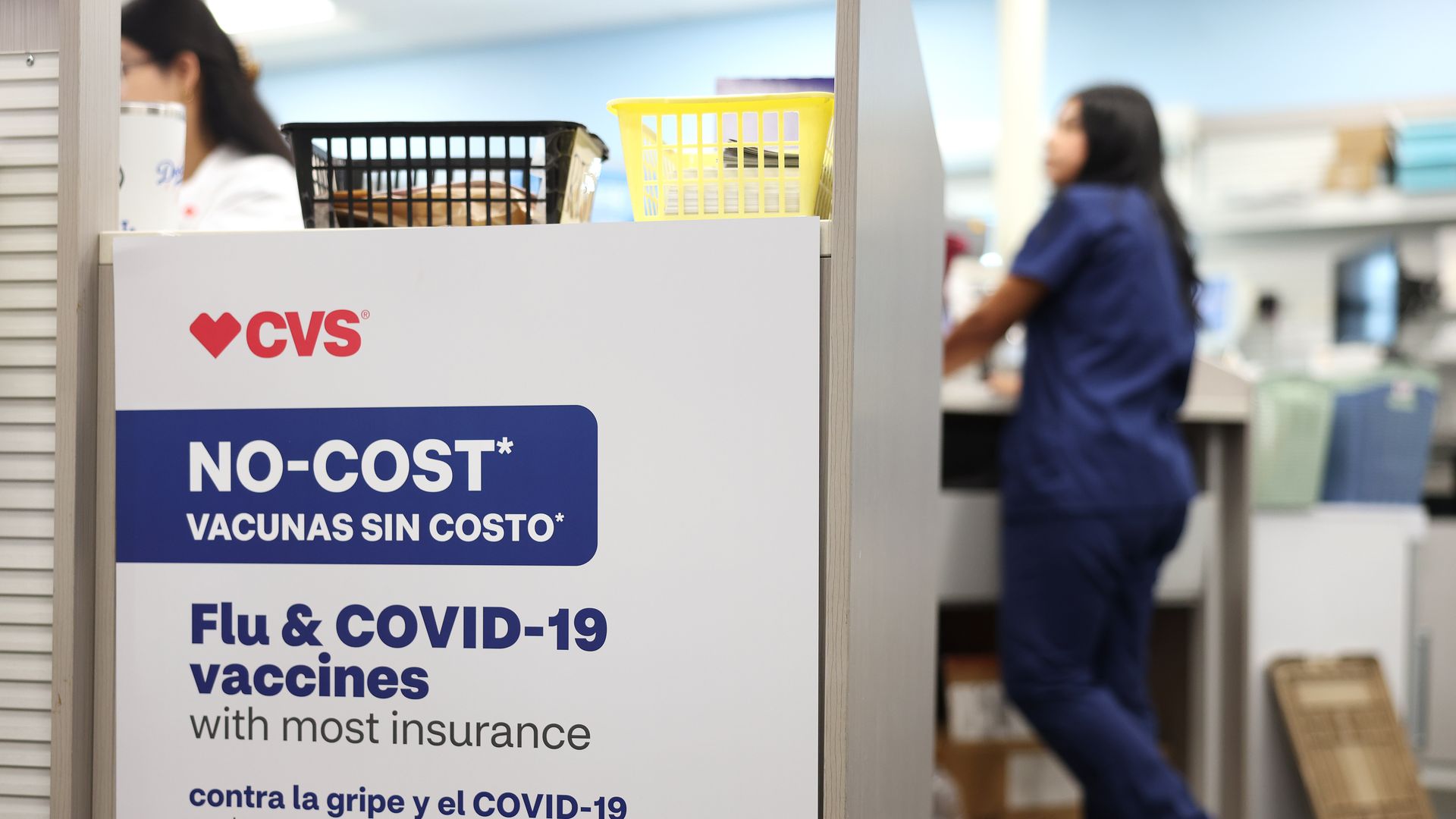 A sign reads "No Cost flu & COVID-19 vaccines with most insurance" at a CVS store pharmacy