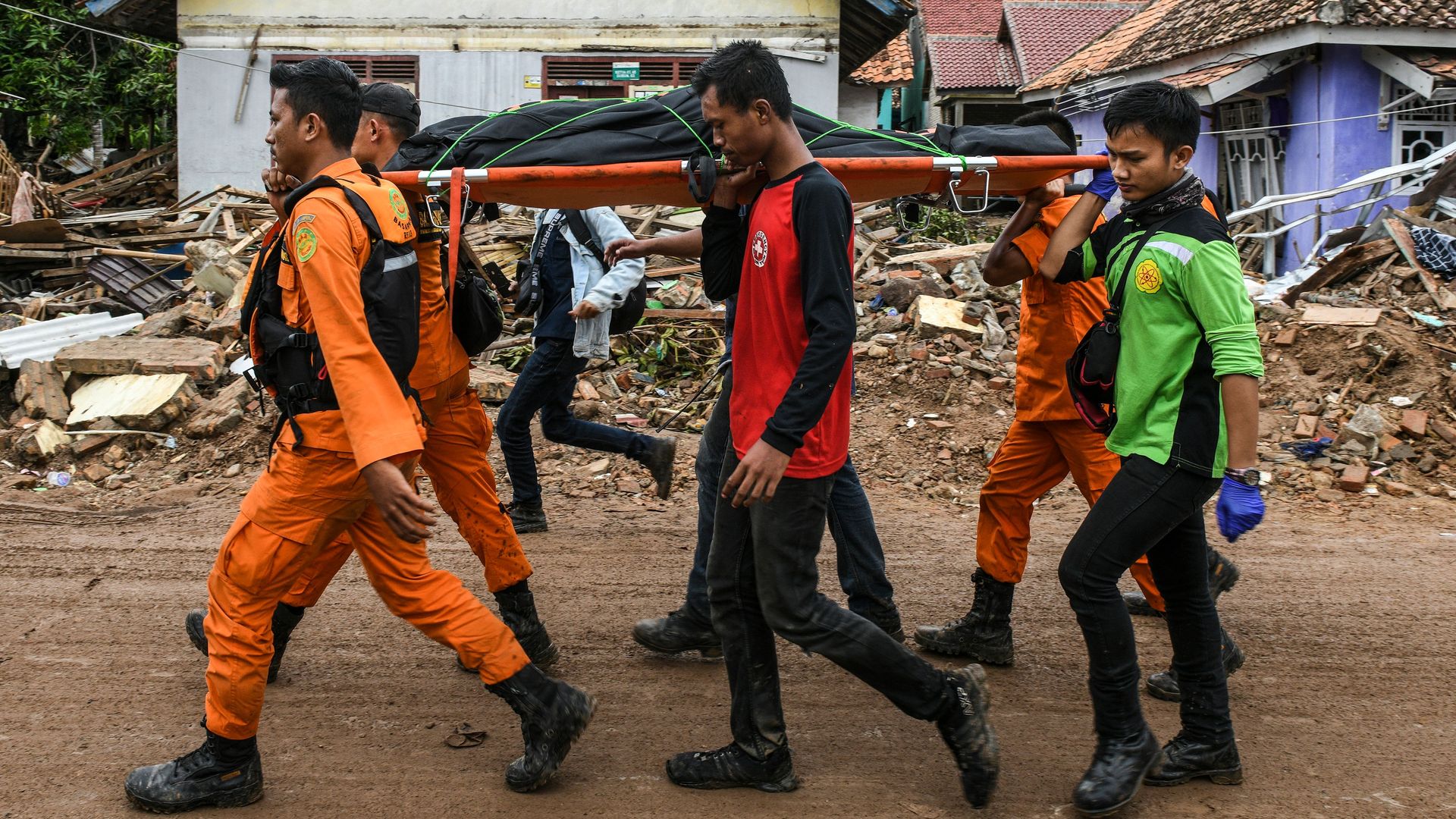 Men carrying a stretcher with a body bag