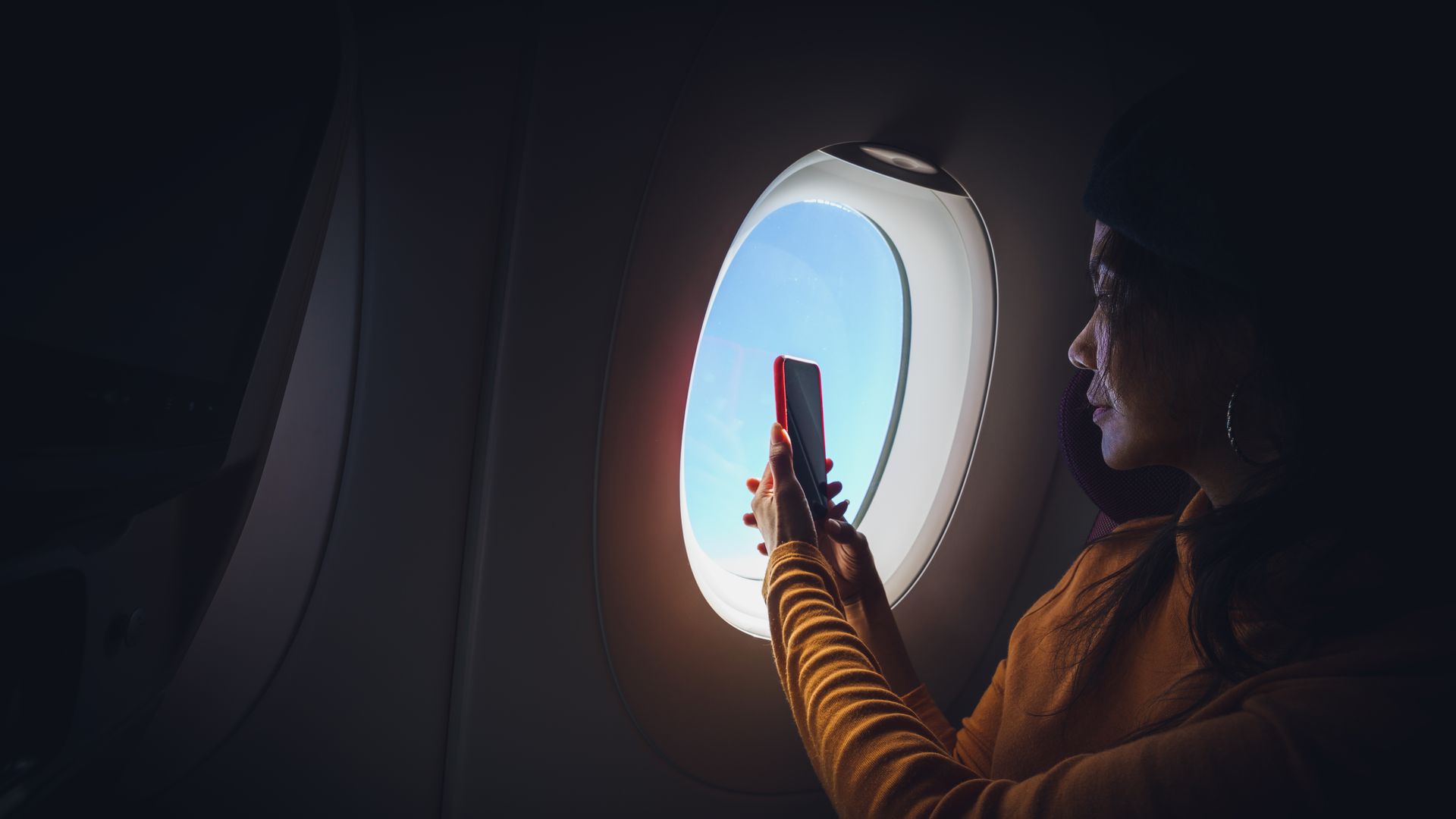 A passenger taking photos from their window seats.