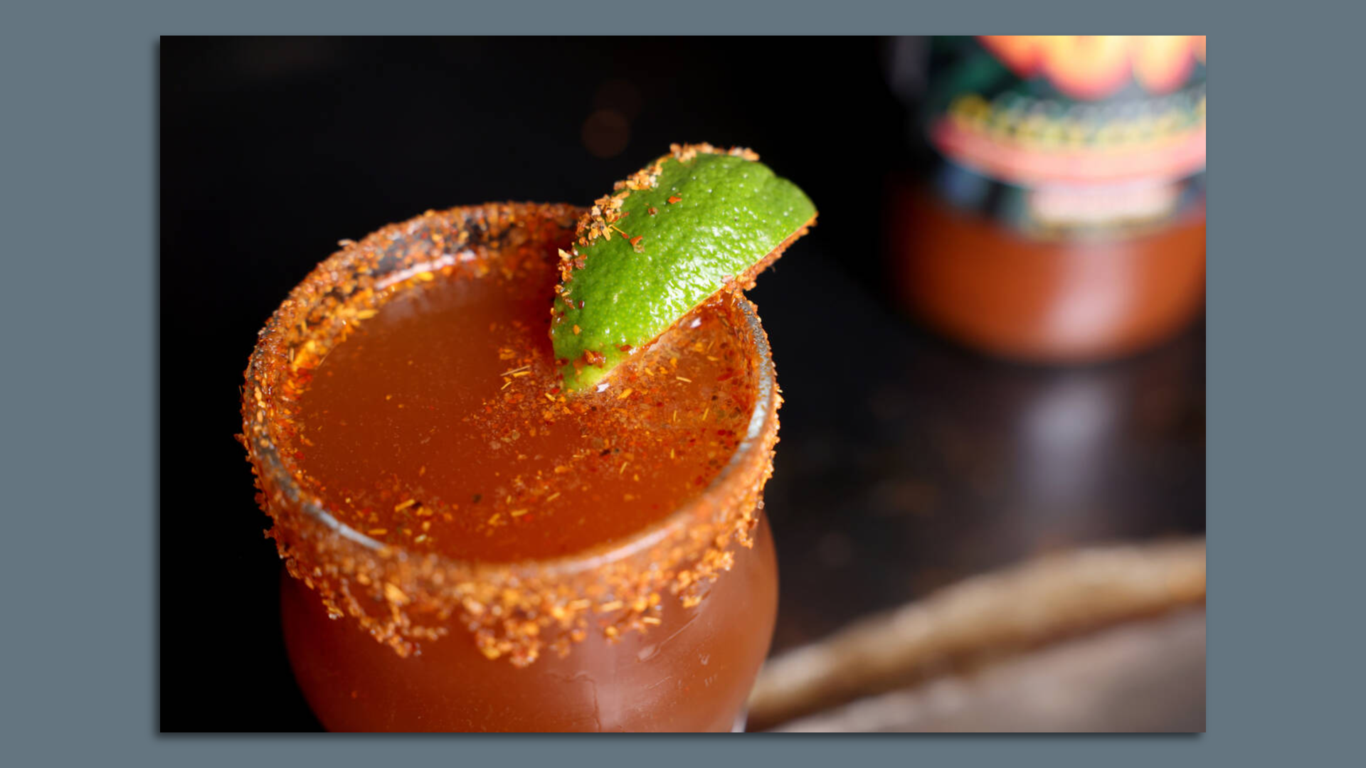 Michelada drink with a lime slice.