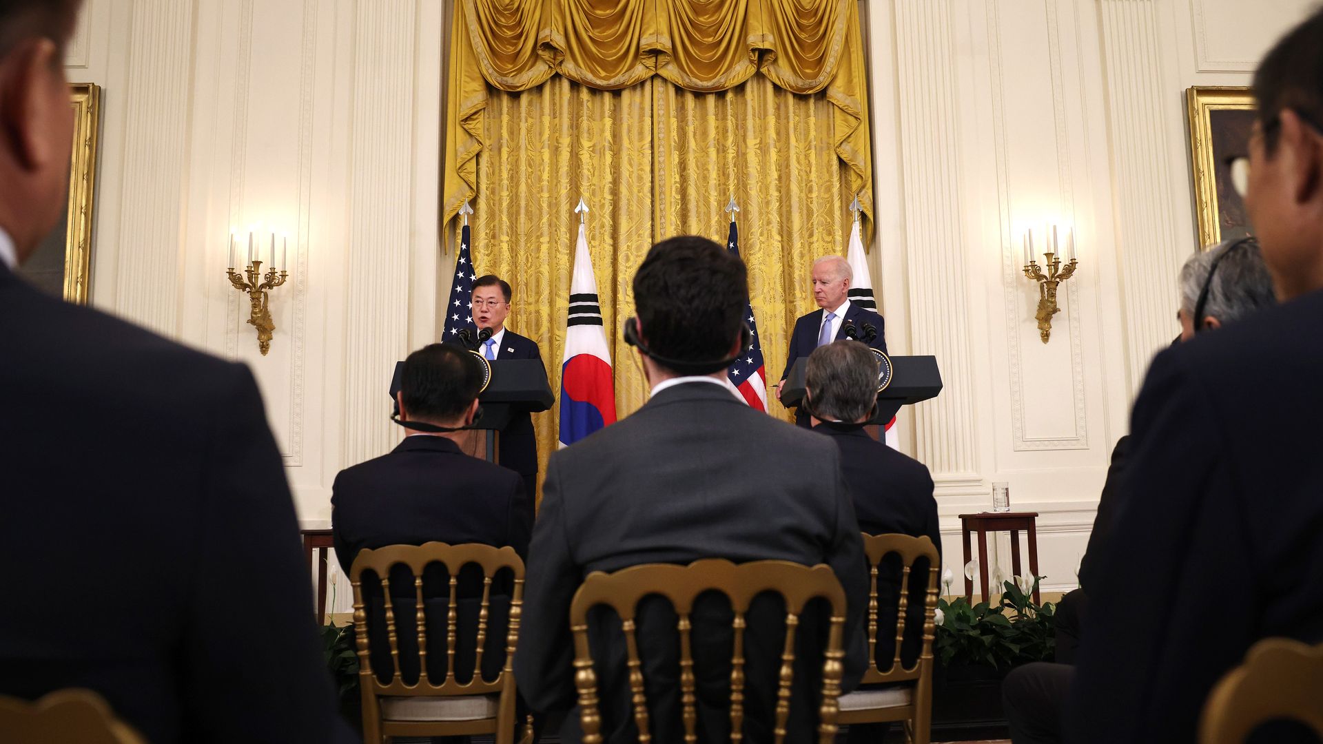 Photo of Moon Jae-in and Joe Biden speaking behind podiums that are positioned next to each other