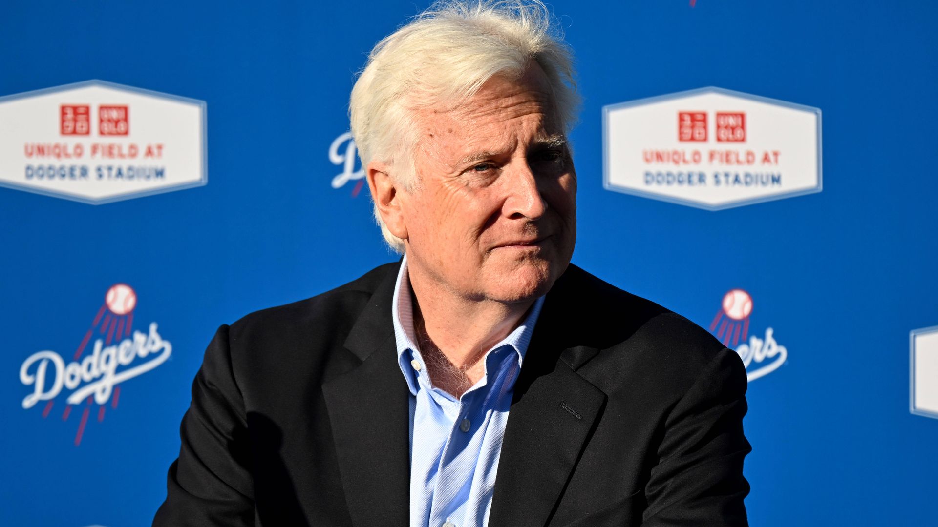 Los Angeles Dodgers chairman Mark Walter sitting at a press conference.