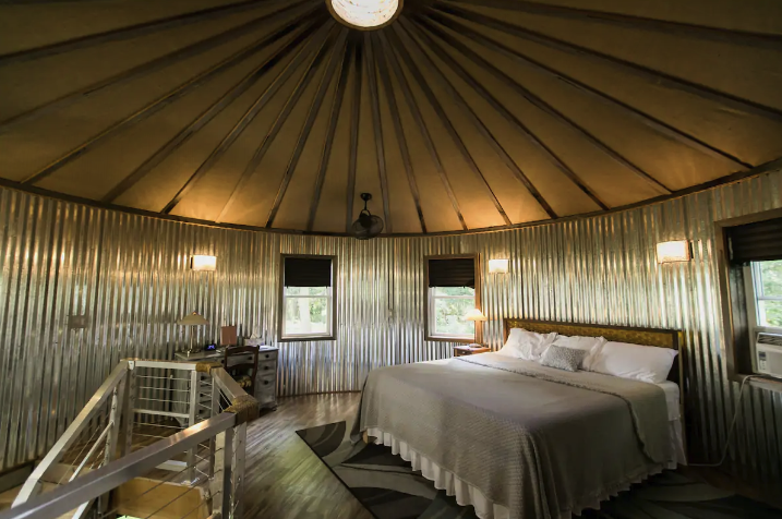 A bedroom inside the round top of a grain bin-turned rental unit.