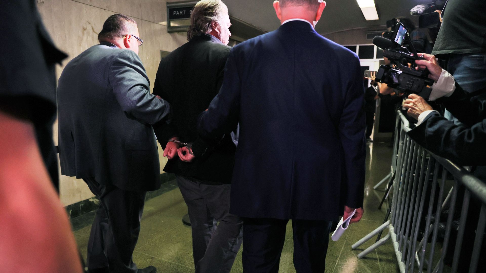 Steve Bannon arrives in handcuffs yesterday for his arraignment in Manhattan on money-laundering charges.